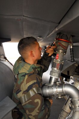 OSAN AIR BASE, Republic of Korea -- Senior Airman Elias Maldonado, F-16 Crew chief, uses a single point nozzle to fuel an F-16 during a peninsula wide exercise here. The exercise Beverly Bulldog 08-01 scenarios test Team Osan's ability to defend the base and conduct daily operations in a combat environment. (U.S. Air Force Photo by Staff Sgt Ronnie Hill) (Released) 