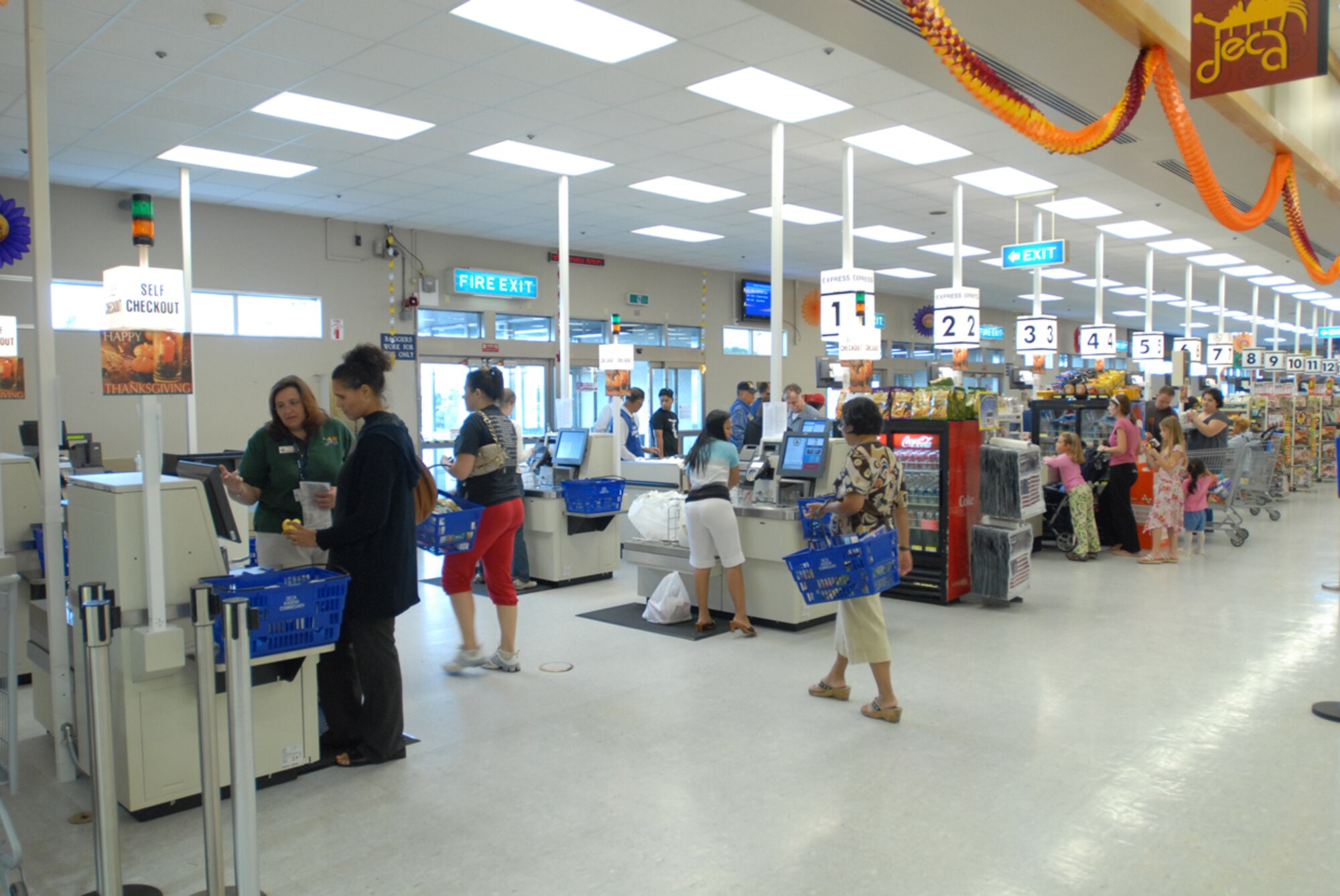 Kadena customers use new self check-out lanes at the commissary Nov. 8. The commissary recently installed four self checkout lanes for customers to get in and out quickly. 
(U.S. Air Force/Airman 1st Class Kasey Zickmund)