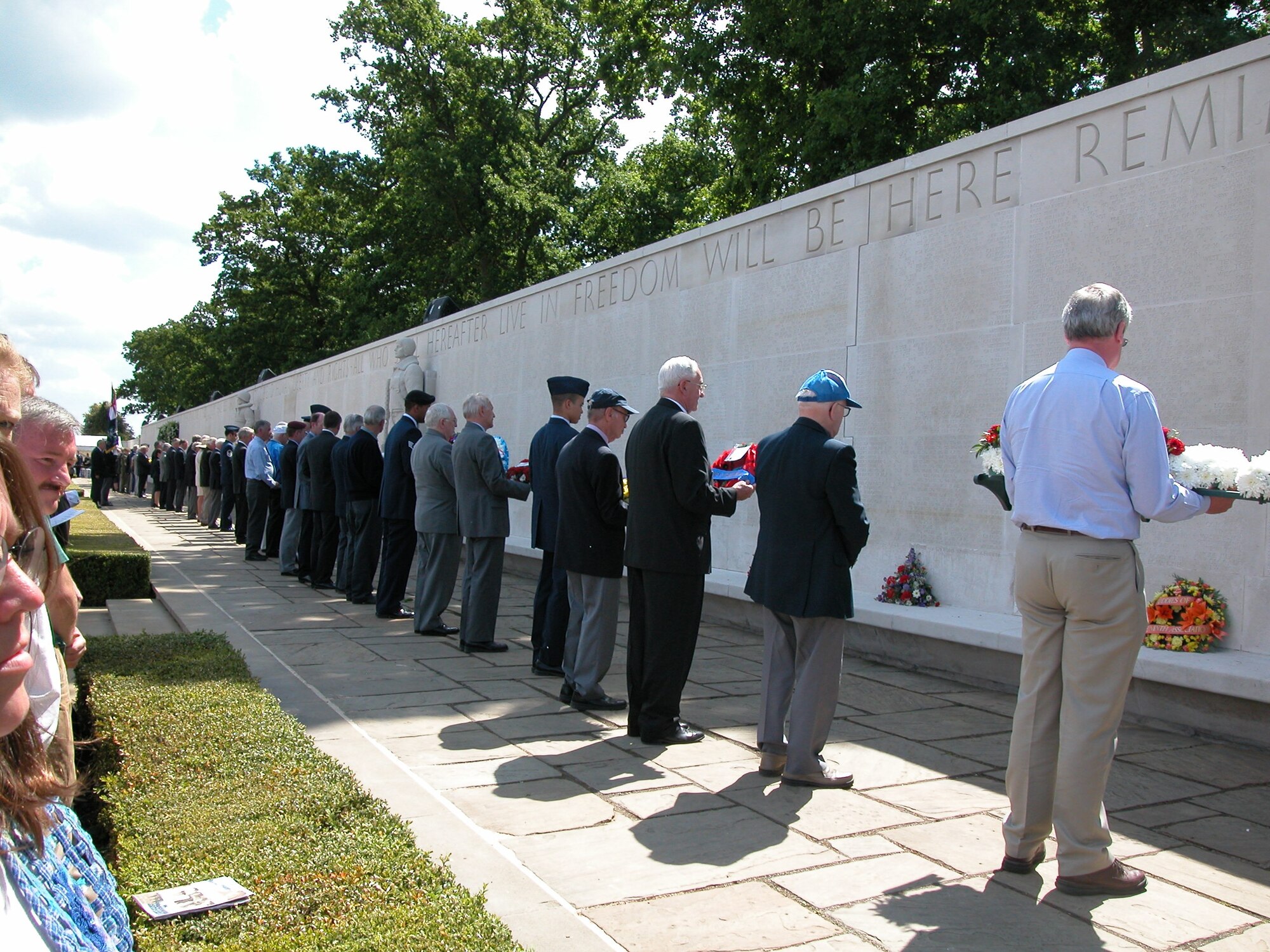 Representatives from various veterans’ organizations place wreaths along the Wall of the Missing during the annual memorial ceremony at the Cambridge, England, American Military Cemetery. (U.S. Air Force photo by Varina Proietti)