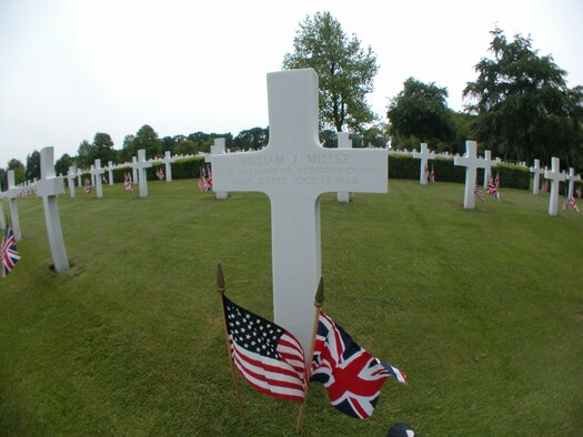 A cross marks the grave of pilot 2nd Lt. William J. Miller of the 452nd Bomb Group, who was killed in an Oct. 12, 1944, crash of the B-17 Inside Curve in England. Seven of his crewmates died with him. (U.S. Air Force photo by Senior Master Sgt. Matt Proietti/452AMW)