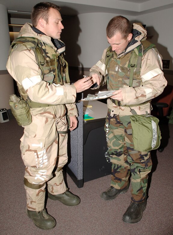 FAIRCHILD AIR FORCE BASE, Wash. – Airman 1st Class Jake Sevy checks Senior Airman Justin Reiter’s, identification card at an entrance to the Thunderbolt 08-01 exercise headquarters. Both Airmen from the 22nd Training Squadron participated in the three-day exercise that simulated a deployment to Korea. (U.S. Air Force photo / Airman 1st Class Darlene West)