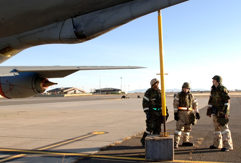 FAIRCHILD AIR FORCE BASE, Wash. -- From left to right, Senior Airman Karon Evans and Staff Sgt. Juan Hernandez, both of the Aircraft Maintenance Squadron, conduct a pre-flight inspection with Capt. Mark Carl, an Air Refueling Squadron pilot, on the flight line Nov. 5. The AMXS and the ARS worked together to simulate operations at a deployed location for the exercise, Thunderbolt 08-01. Approximately 200 Airmen “deployed” to Camp Airey here to participate in the exercise. (U.S. Air Force photo / Airman 1st Class Darlene West)