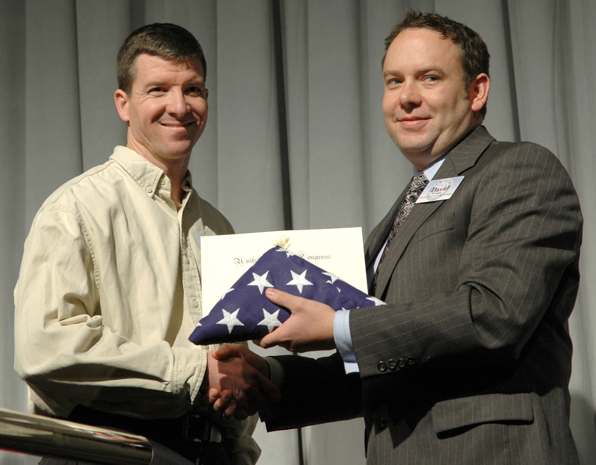 FAIRCHILD AIR FORCE BASE, Wash. -- Maj. Curtis Wichers, 36th Rescue Flight commander, is presented a folded flag and a certificate from David Condon, Deputy Chief of Staff District Director, during a ceremony Nov. 7 honoring hometown heroes. Major Wichers was presented the certificate in recognition of his great commitment to the people of Eastern Washington. (U.S. Air Force photo/Tech. Sgt. Larry W. Carpenter Jr.)