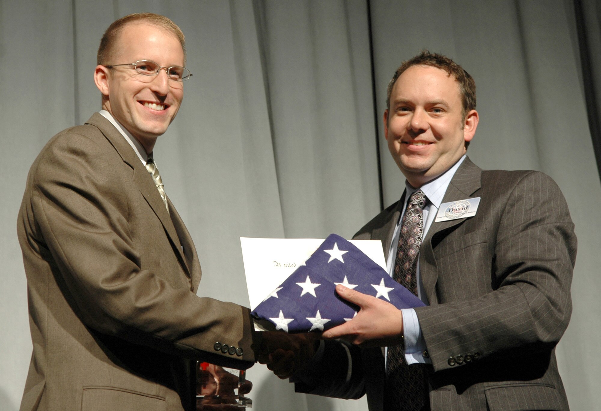 FAIRCHILD AIR FORCE BASE, Wash. -- Capt. Jarrett McNabb, 92nd Air Refueling Wing executive officer and KC-135 Stratotanker pilot, is presented a folded flag and a certificate from David Condon, Deputy Chief of Staff District Director, during a ceremony Nov. 7 honoring hometown heroes. Captain McNabb and Staff Sgt. Tiana Church both received the Military Hero award for their lifesaving actions and commitment to training. (U.S. Air Force photo/Tech. Sgt. Larry W. Carpenter Jr.)