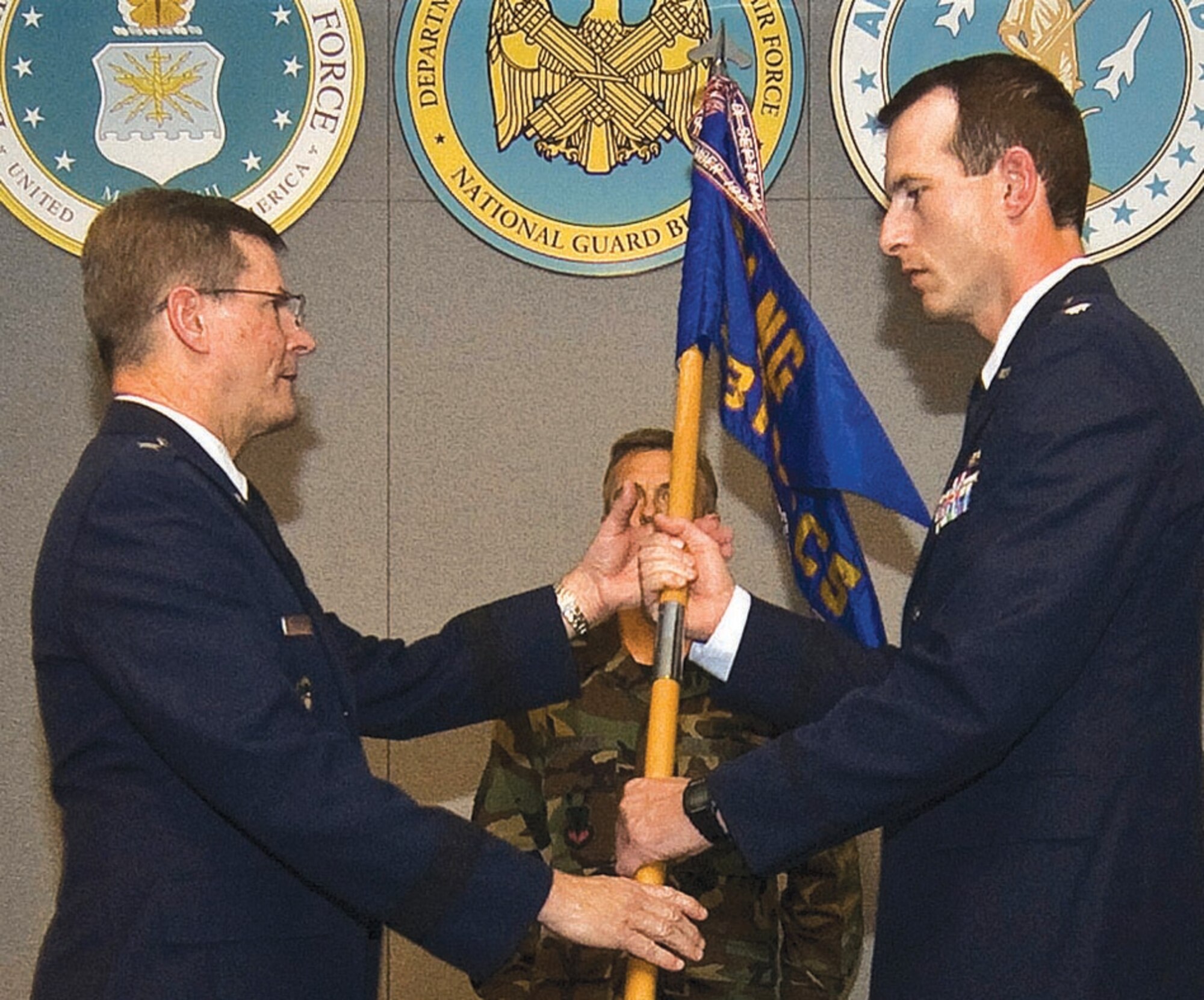 Brig. Gen. Richard Prosek receives the 231st Combat Communications Squadron Guidon from Lt. Col. Robert D. Price, 231 CCS commander, during the inactivation ceremony. The 231 CCS's mission was to provide rapidly mobile, highly secure, state-of-the-art communications  services to the United States of America and the District of Columbia. 
