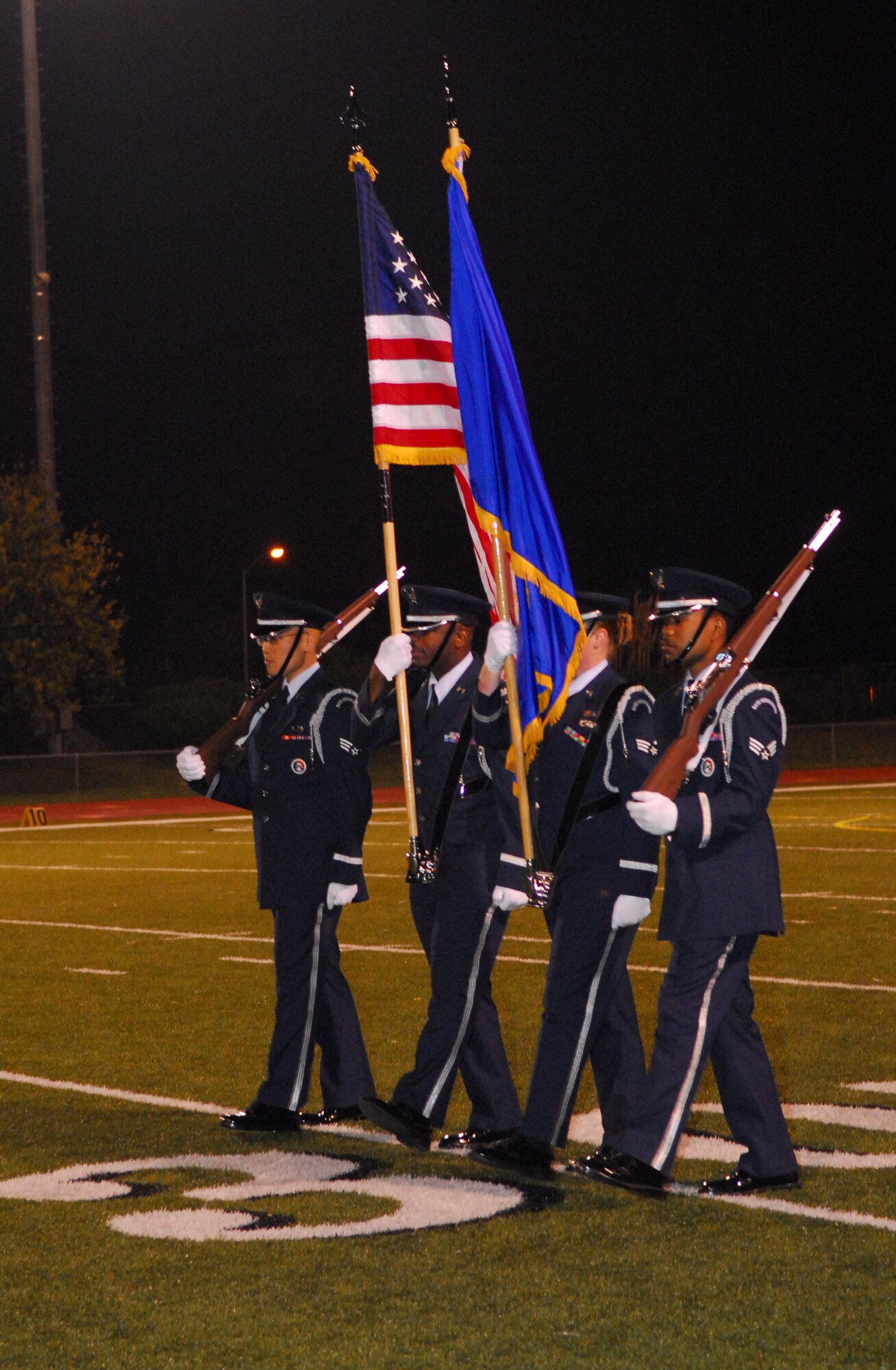 SANTA MARIA, Calif. -- The Vandenberg Air Force Base honor guard present the U.S. flag prior to the singing of the national anthem during the 5th annual Allan Hancock College military appreciation night on Nov. 3. Allan Hancock College lost 23-36 to Bakersfield College. The event is held to support military members. The first 250 military members, veterans and their families were admitted at no charge and served a free tri-tip dinner. The Santa Maria Valley Chamber of Commerce, Coast Hills Federal Credit Union, and Allan Hancock College sponsored this special event. 

(U.S. Photo/Airman First Class Ashley Tyler)