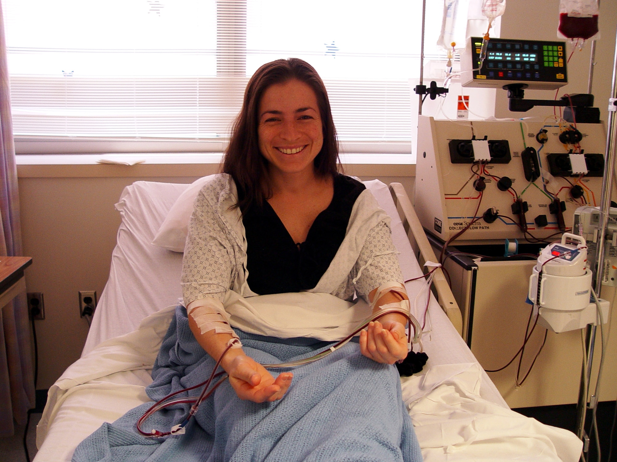 Tech. Sgt. Mari Navarro donates her blood stem cells back in 2004. On Nov. 8, in Washington D.C., Sergeant Navarro donated again to the same woman she first helped; hopefully, giving the recipient a third chance at life. Sergeant Navarro is the NCO in charge of military personnel field activities for the manpower, personnel and services directorate at Air Force Space Command, Peterson Air Force Base, Colo.(Courtesy photo)