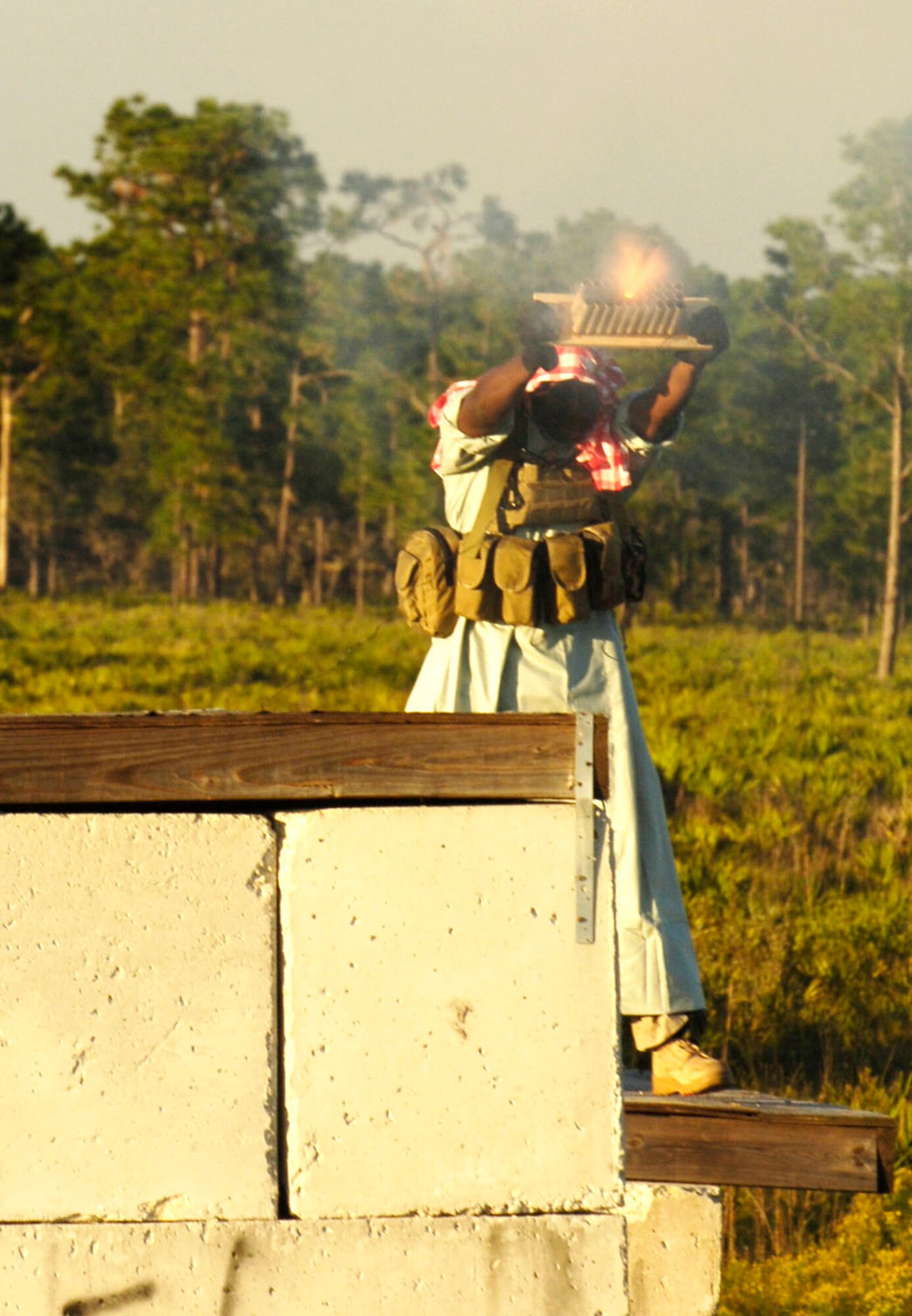 Airman 1st Class Daryl Cooper, a Tactical Air Control Party member from the 19th Air Support Operations Squadron in Fort Campbell, Kentucky launches a multiple flare launcher simulating a rocket attack against an advancing Army platoon in the Avon Park Air Ground Training Complex in Avon Park, Fla.  The training scenario is part of exercise Atlantic Strike VI, a U.S. Central Command Air Forces-sponsored training event designed to improve air-ground coordination during urban close air support operations.