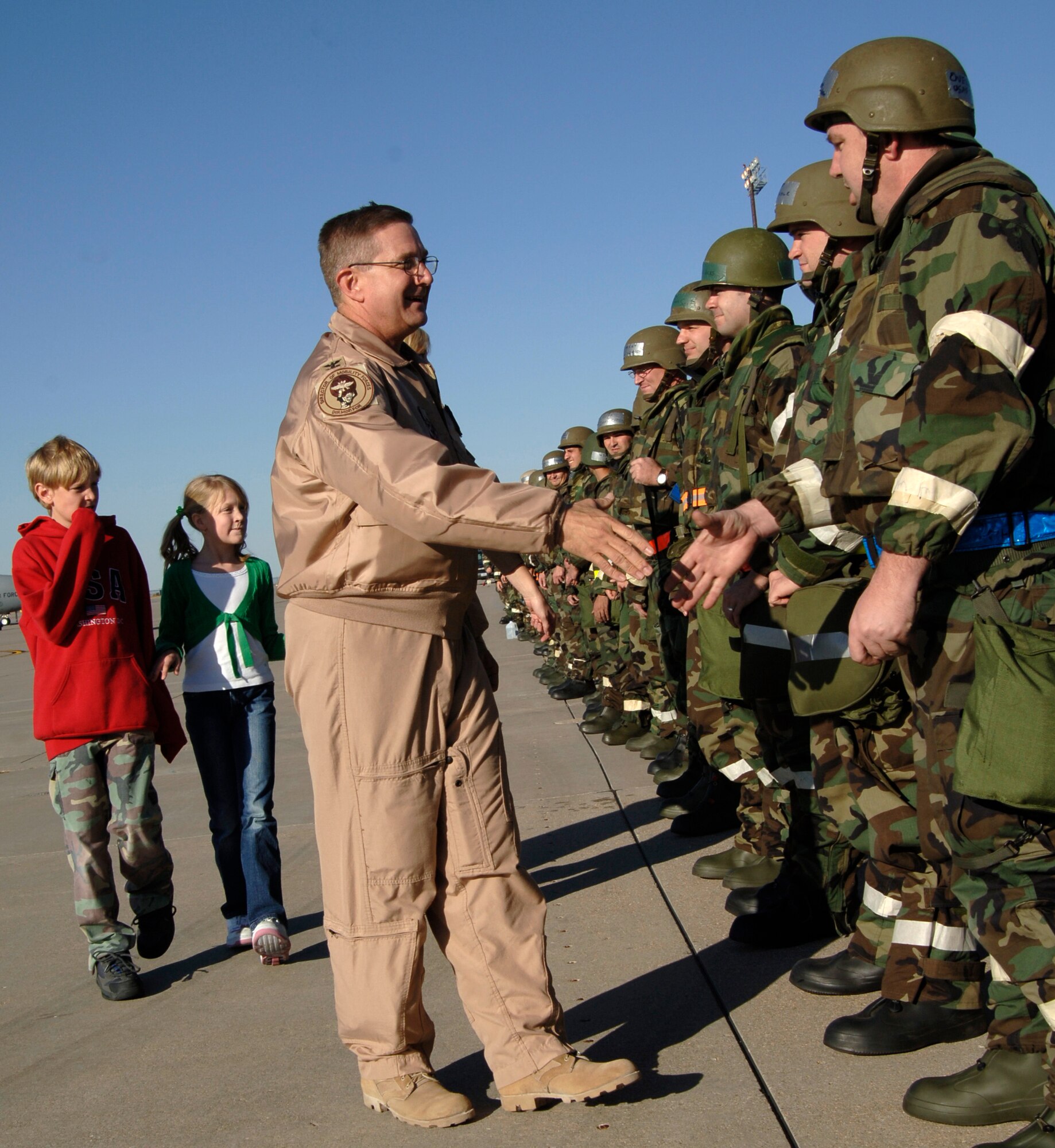 MCCONNELL AIR FORCE BASE, Kan. -- Colonel Donald Halpin, 22nd Air Refueling Wing Commander, accompanied by family shake hands of McConnell Team Members on the flight line Nov. 6. Estimated 200 Airmen came out to welcome Col. Halpin home from a four month deployment. (Photo by Airman 1st Class Roy Lynch)