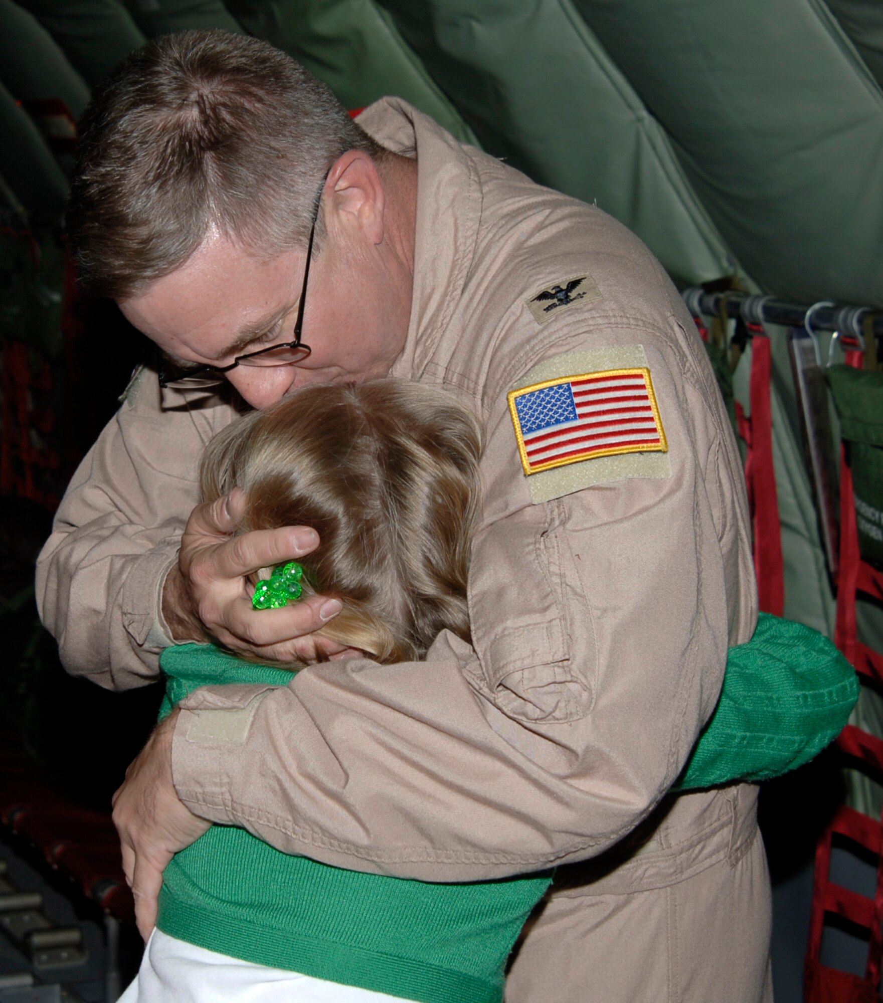 MCCONNELL AIR FORCE BASE, Kan. – Col. Donald Halpin, 22nd Air Refueling Wing Commander, embraces daughter Margaret Rose on the flight line Nov. 6. Col. Halpin’s family went on board the plane to surprise their loved one. (Photo by Airman 1st Class Roy Lynch)