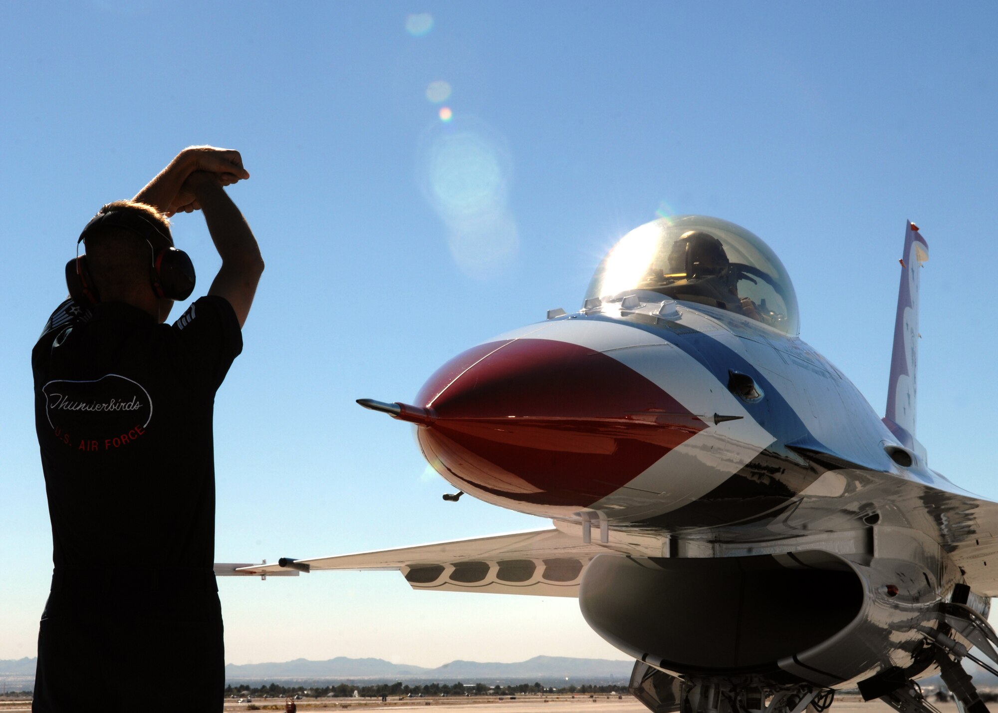 NELLIS AIR FORCE BASE, Nev. -- Staff Sgt. Wayne Frost, U.S. Air Force Air Demonstration Squadron crew chief, recovers the newest addition to the U.S. Air Force Thunderbirds, a Block-52 Lockheed-Martin Fighting Falcon F-16. In addition to the new F-16, the Thunderbirds also welcomed five new officers for the 2008 demo season, including the incoming commander, Lt. Col. Gregory Thomas from Elmendorf Air Base, Alaska; incoming right-wing pilot, Thunderbird No. 3, Maj. Kirby Ensser from Kadena Air Base, Japan; opposing solo pilot and Thunderbird No. 6, Maj. Tyrone Douglas from the 57th Fighter Wing here; advance pilot and narrator, Thunderbird No. 8, Maj. Anthony Mulhare from Luke AFB, Ariz.; and flight surgeon and Thunderbird No. 9, Maj. (Dr.) Charla Quayle from the 99th Medical Group here. (U.S. Air Force photo/Staff Sgt. Kristi Machado)