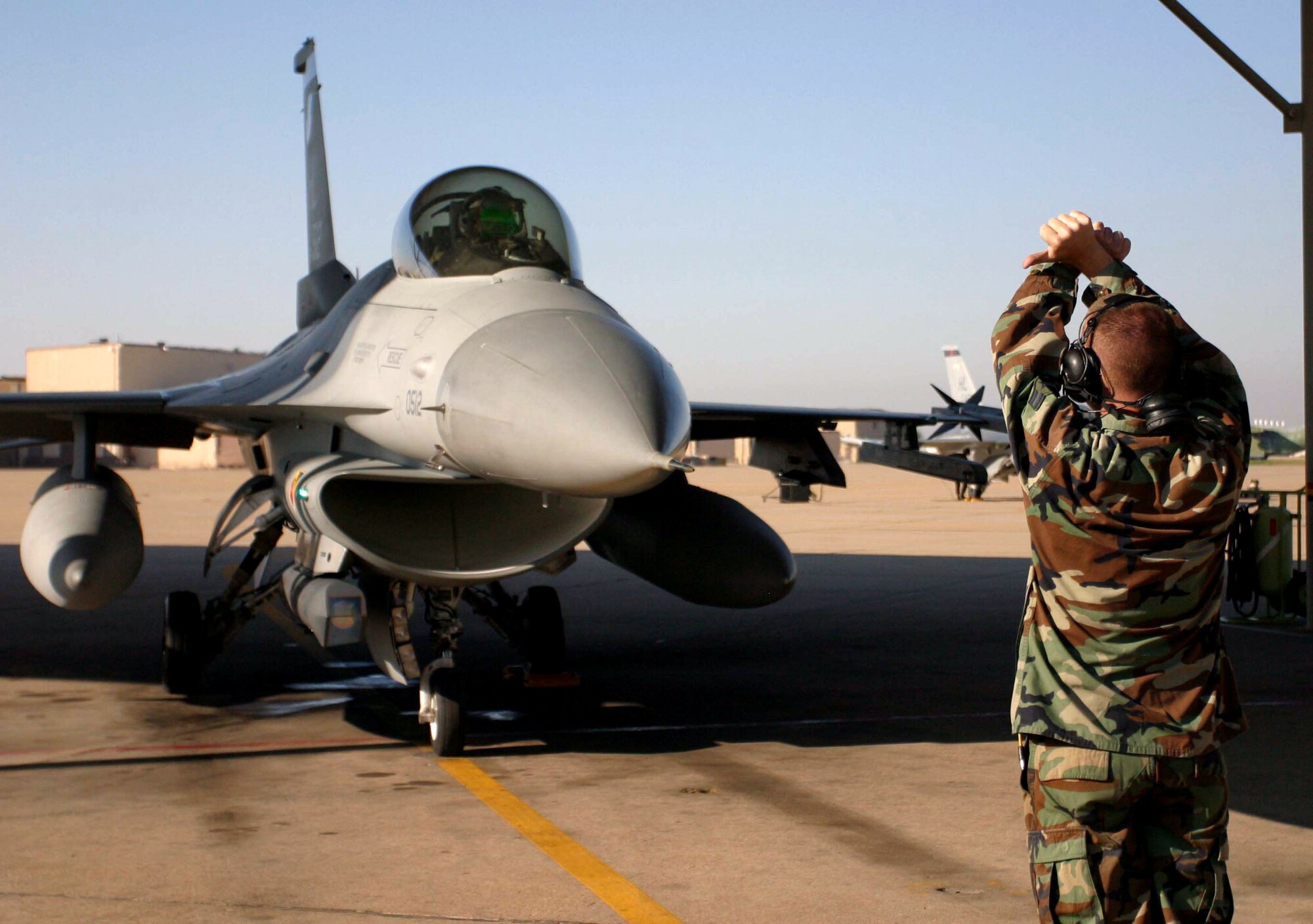 Airman 1st Class Jeremy Meyers, 34th Fighter Squadron crew chief, prepares Lt. Col. Kurt Gallegos, 419th Fighter Wing pilot, for flight. Reserve pilots and maintainers from the 419th FW now work alongside active-duty Airmen from the 388th Fighter Wing as part of the Air Force's Total Force Integration initiative aimed at increasing combat capabilities and efficiencies among like units. (U.S. Air Force photo/Senior Airman Stefanie Torres) 
