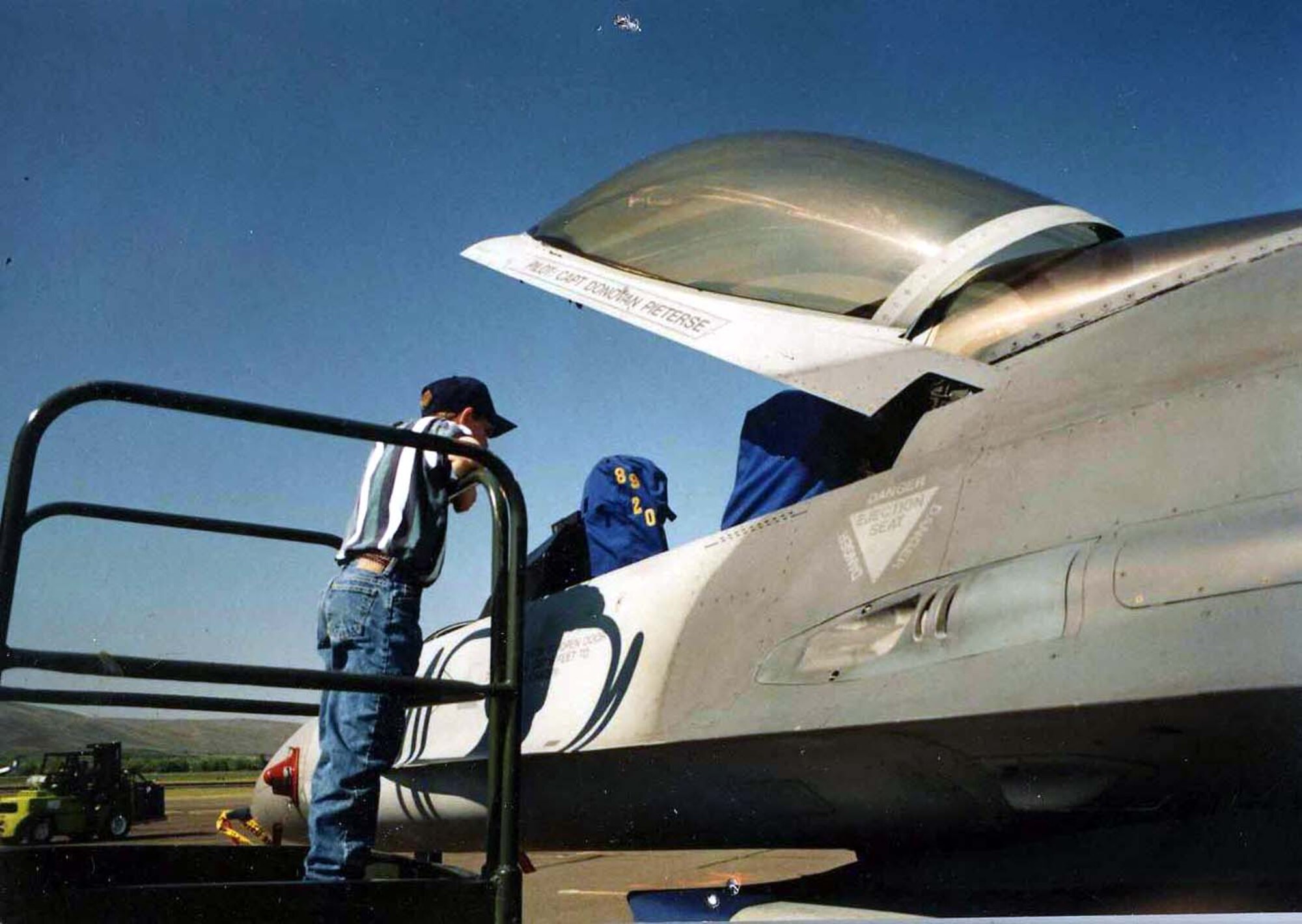 Senior Airman Jeremy Meyers seen here at 9 years old looking into an F-16 Fighting Falcon at an airshow. (Courtesy photo)
