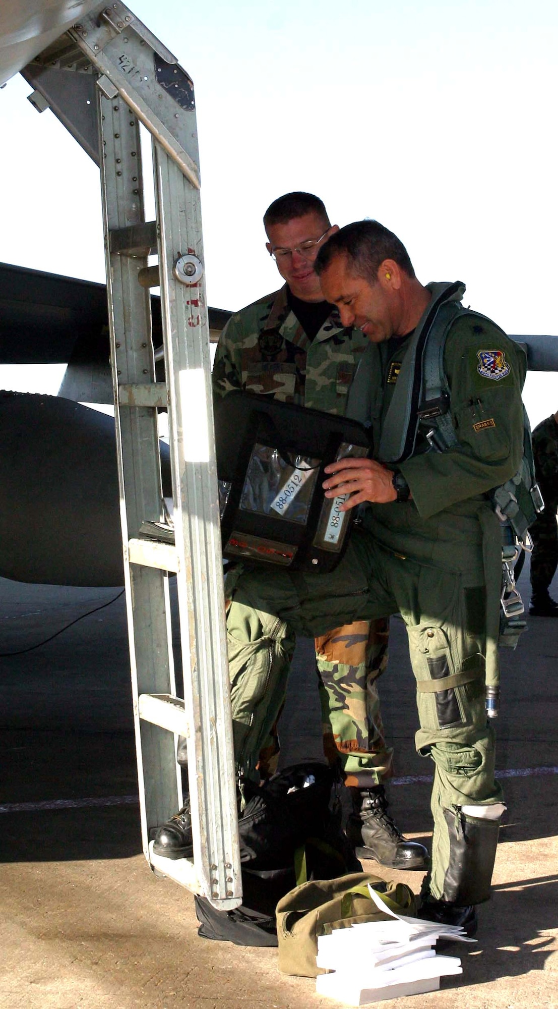 Airman 1st Class Jeremy Meyers and Lt. Col. Kurt Gallegos review procedures before flight. Airman Meyers was able to meet Colonel Gallegos and was also given the opportunity to work as his crew chief for the day. (U.S. Air Force photo/Senior Airman Stefanie Torres) 
