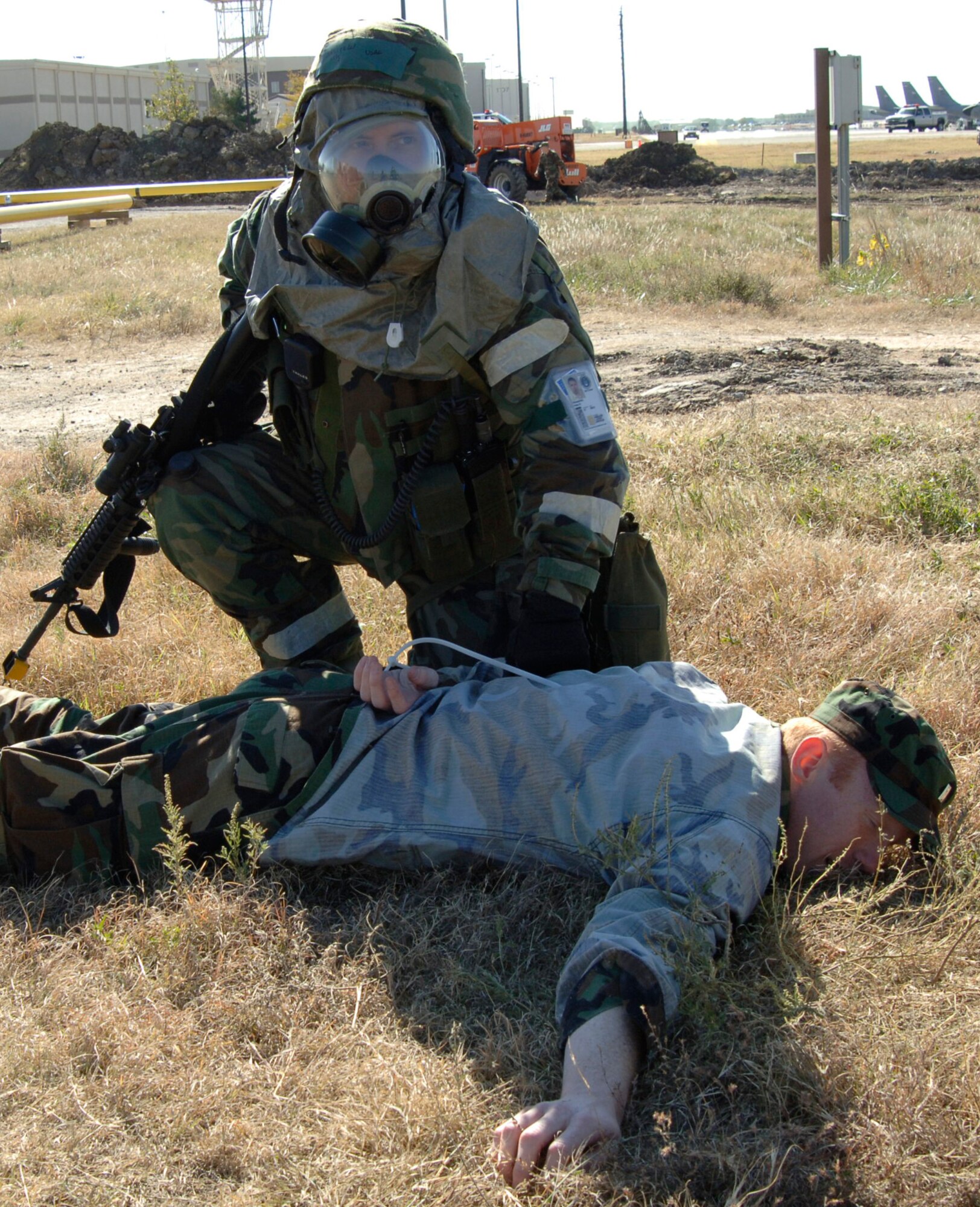 MCCONNELL AIR FORCE BASE, Kan. -- Master Sgt. Peter Nusspickel, 22nd Security Forces Squadron, holds down 1st Lieutenant Andrew Washburn, 349th Air Refueling Squadron at the Alert Facility Bldg. 978 during the Injured Walker exercise Nov. 06. Injured Walker exercise is in preparation for the Operational Readiness Inspection which will assess McConnell’s ability to execute its wartime or contingency mission. (Photo by Airman 1st Class Roy Lynch) 