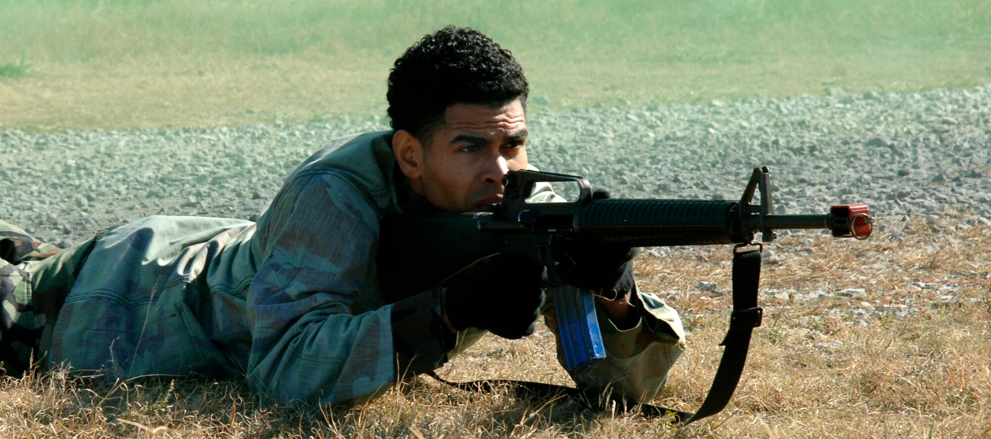 MCCONNELL AIR FORCE BASE, Kan. -- Airman Jesus Ramirez, 22nd Aero Medical Squadron, lays down cover fire while other McConnell Team aggressors run to the Alert Facility Bldg. 978 during the Injured Walker exercise Nov. 06. Injured Walker exercise is preparing the Wing for an Operational Readiness Inspection scheduled June 20-29. (Photo by Airman 1st Class Roy Lynch) 