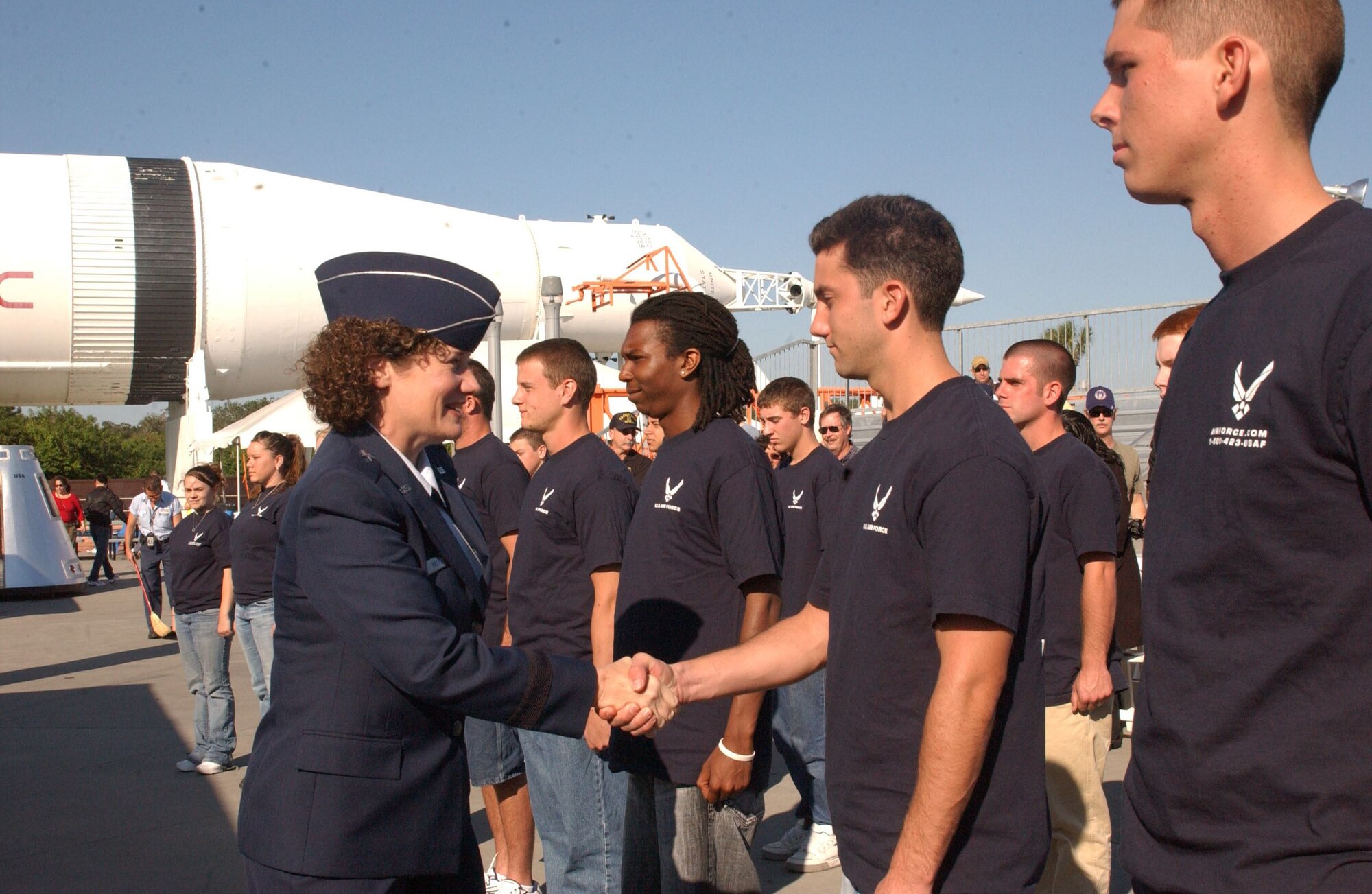 Brig. Gen. Susan Helms, 45th Space Wing commander, congratulates new Air Force enlistees during a swear-in ceremony for 17 Airmen in the delayed entry program. The ceremony took place at the Kennedy Space Center Visitor’s Complex Rocket Garden Nov. 2. (USAF photo by Tech. Sgt. Tom Czerwinski)