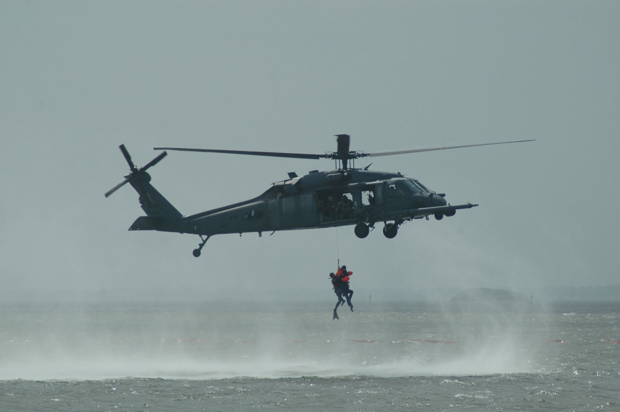 Para-rescuemen from the 920th Rescue Wing, retrieve a “downed” pilot from the Banana River during a mock-rescue exercise during the World Space Expo. The rescue was performed with the use of a specially equipped HH-60 Pavehawk search and rescue helicopter. (USAF photo by Maj. Greg Harland)