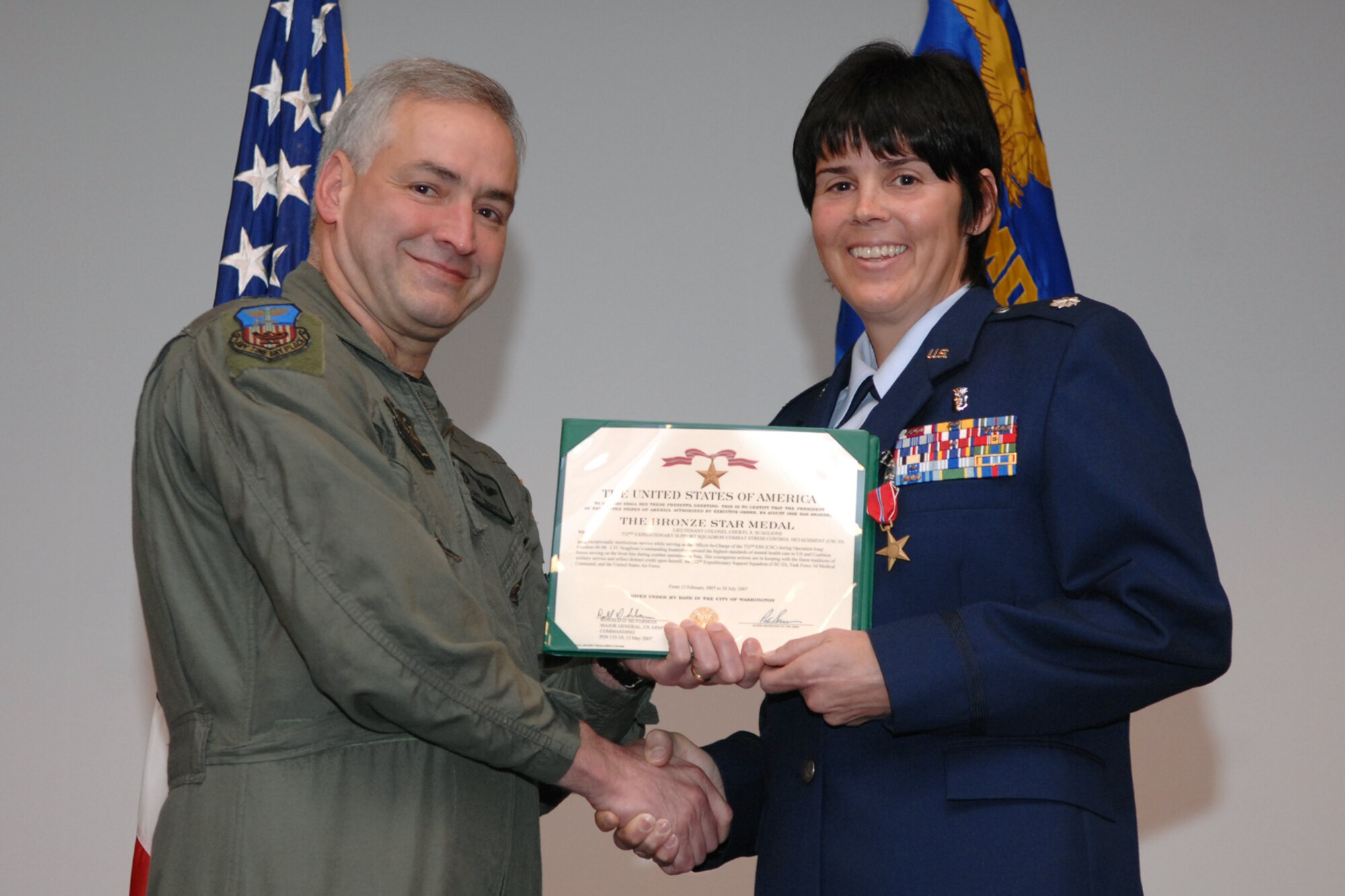 Col. David Rhodes, 1st Special Operations Medical Group commander, presented Lt. Col. Cheryl Scaglione a Bronze Star Nov. 5 for her actions as the officer-in-charge of the 732nd Expeditionary Support Squadron’s combat stress control clinics in Iraq. Colonel Scaglione is the first member of the 1st SOMDG, officer or enlisted, to receive the Bronze Star in support of Operation Iraqi Freedom. (U.S. Air Force photo by Senior Airman Julianne Showalter)