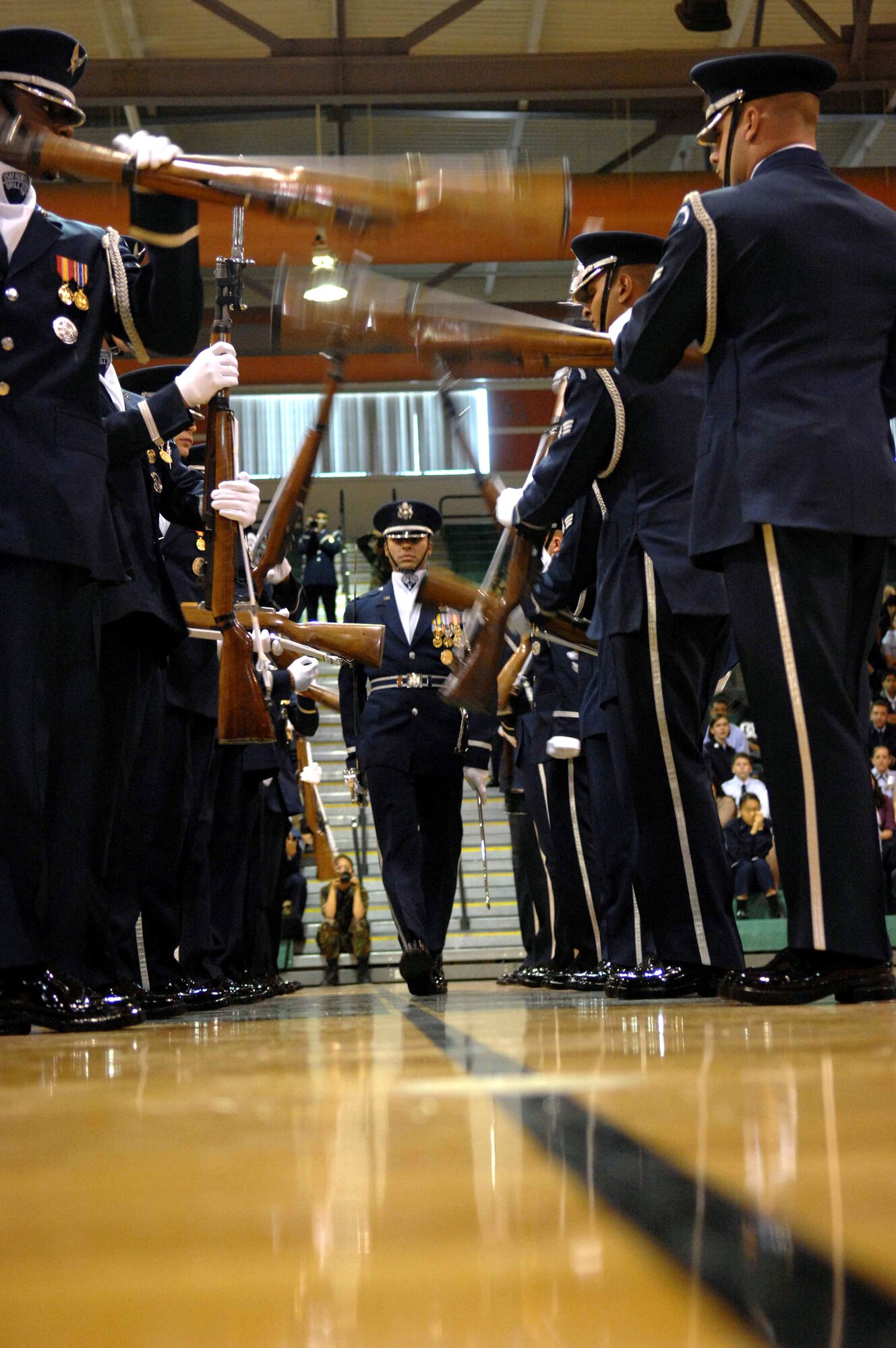 Capt. Joshua Hawkins (center) walks through the gauntlet during the Air Force Honor Guard drill team performance at the Palo Verde High School gym Nov. 6 in Las Vegas. The Air Force Honor Guard drill team is in Las Vegas for 14 performances throughout the military and civilian community, and will perform during the Air Force 60th Anniversary Air Show and opening for Tops In Blue. Captain Hawkings is the Air Force Honor Guard drill team commander. (U.S. Air Force photo/Senior Airman Larry E. Reid Jr.) 
