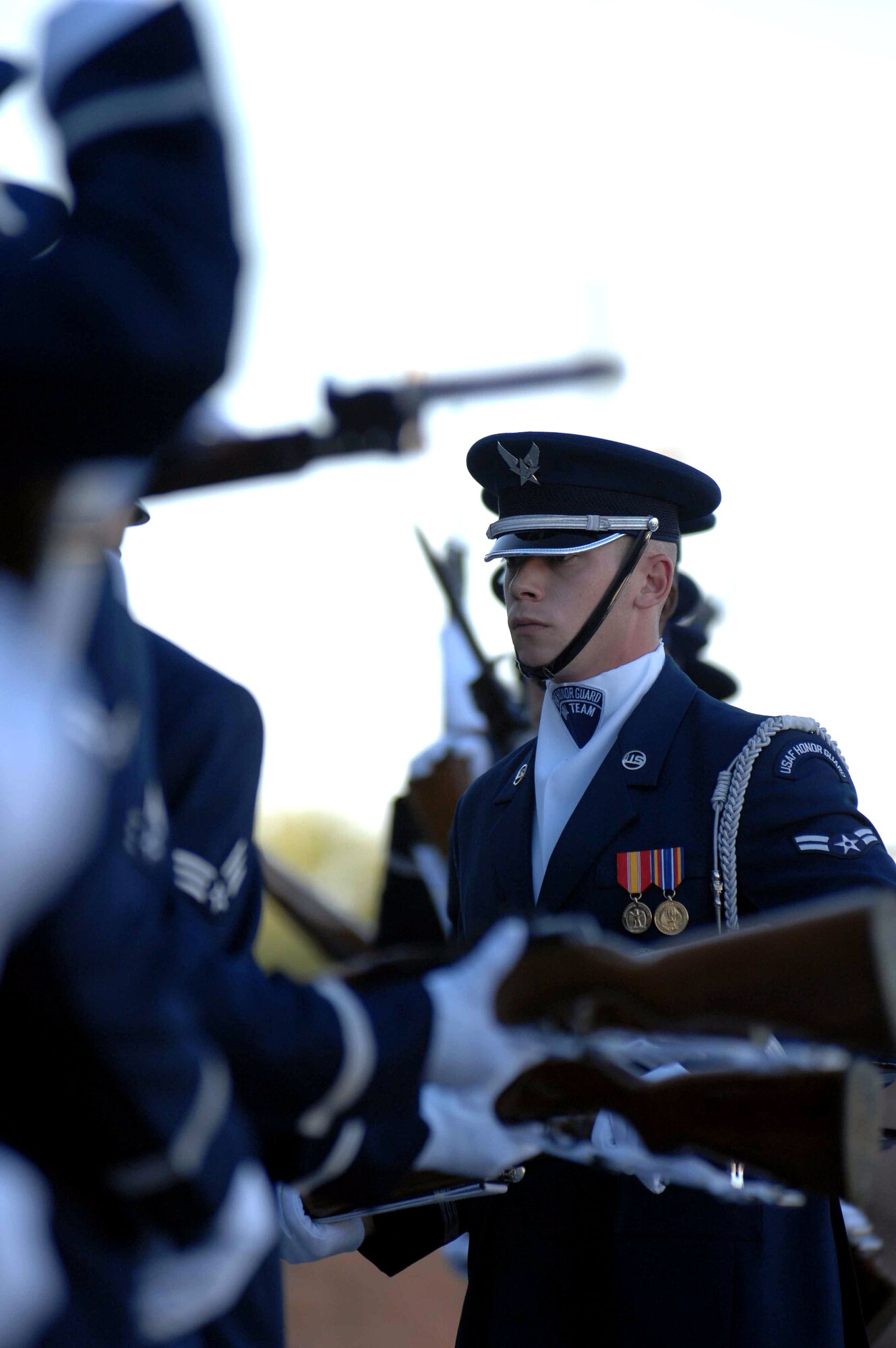 Members of the Air Force Honor Guard drill team perform in front of the Thunderbird Hangar Nov. 6 at Nellis Air Force Base, Nev. The Air Force Honor Guard drill team is in Las Vegas for 14 performances throughout the military and civilian community and will perform during the Air Force 60th Anniversary Air Show and opening for Tops In Blue. (U.S. Air Force photo/Senior Airman Larry E. Reid Jr.) 

