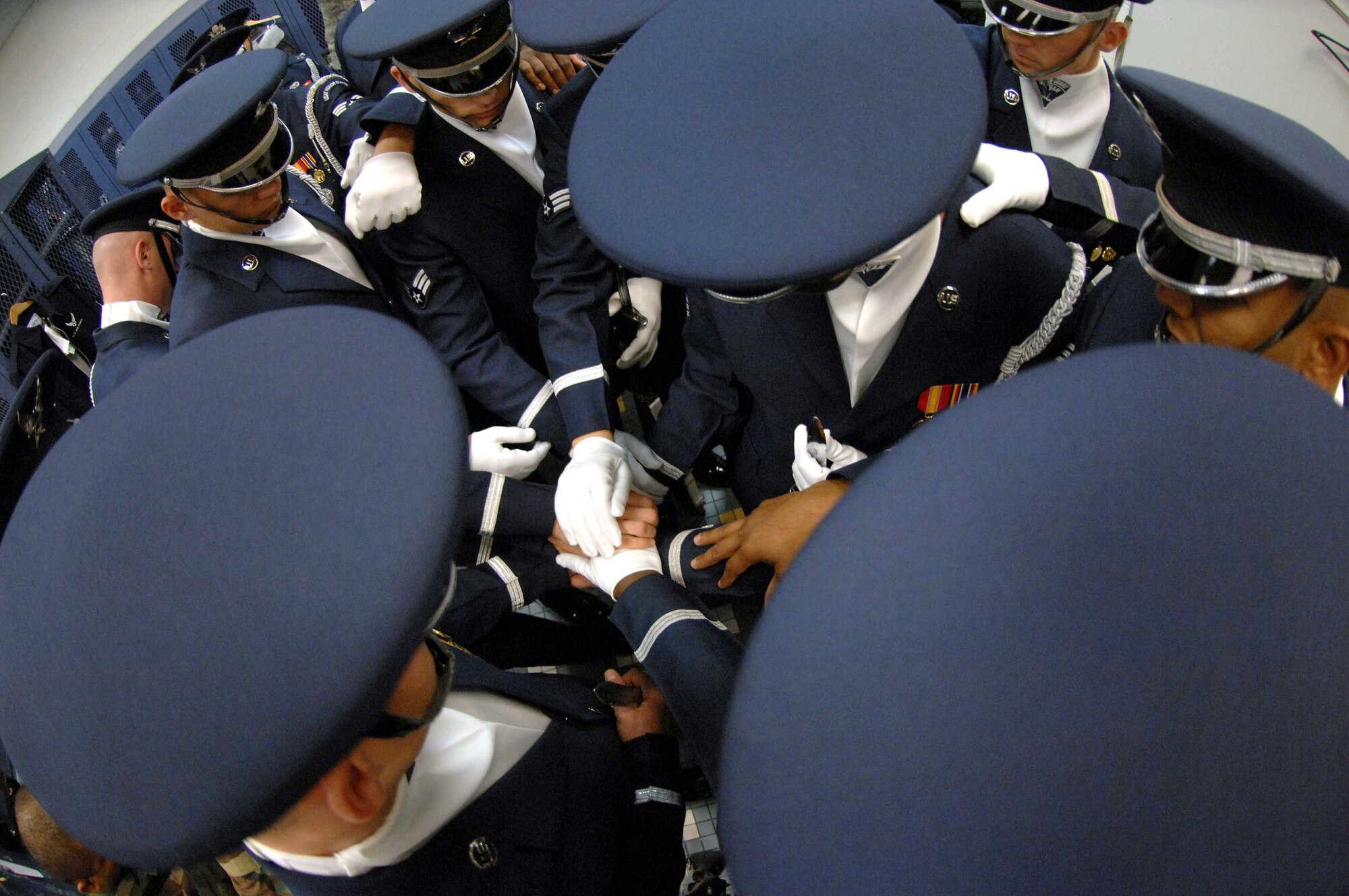 Members of the Air Force Honor Guard drill team gather for a word of prayer before their performance at the Palo Verde High School Gym Nov. 6 in Las Vegas. The Air Force Honor Guard drill team is in Las Vegas for 14 performances throughout the military and civilian community. They will be performing during the Air Force 60th Anniversary Air Show and opening for Tops In Blue. (U.S. Air Force photo/Senior Airman Larry E. Reid Jr.) 
