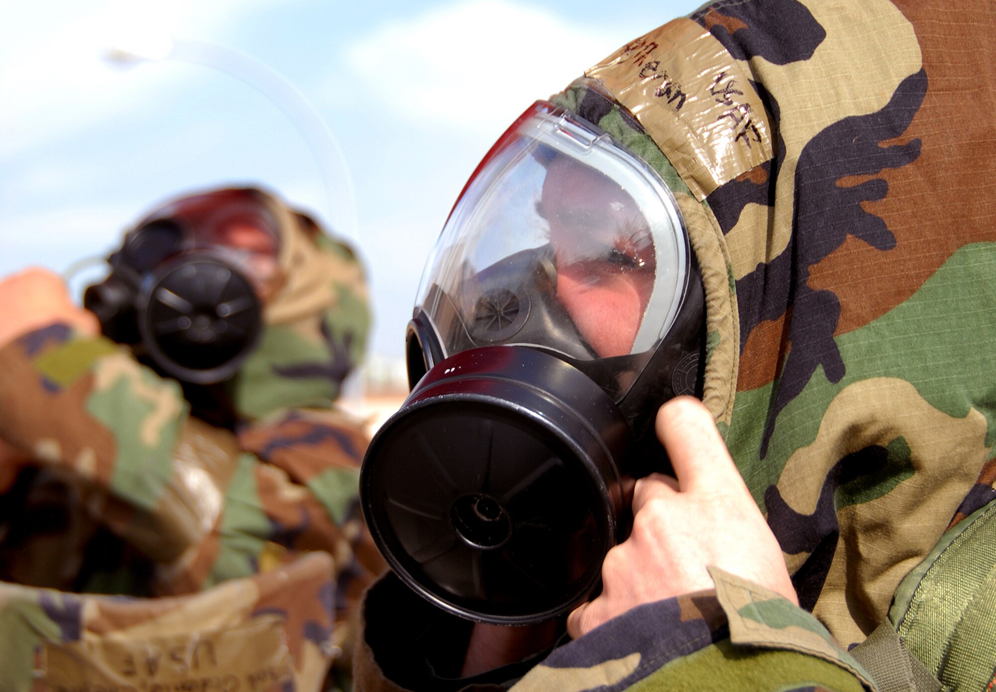 OSAN AIR BASE, Republic of Korea --  Airman 1st Class Theran Hedtke, 51st Communications Squadron, goes in to Mission Oriented Protective Posture (MOPP) 4 during a simulated attack on Bldg. 949 Nov. 6. Beverly Bulldog 08-01, a peninsula-wide operational readiness exercise, tests Team Osan's ability to defend the base and conduct daily operations in a combat environment.  (U.S. Air Force Photo by Airman First Class Chad Strohmeyer)