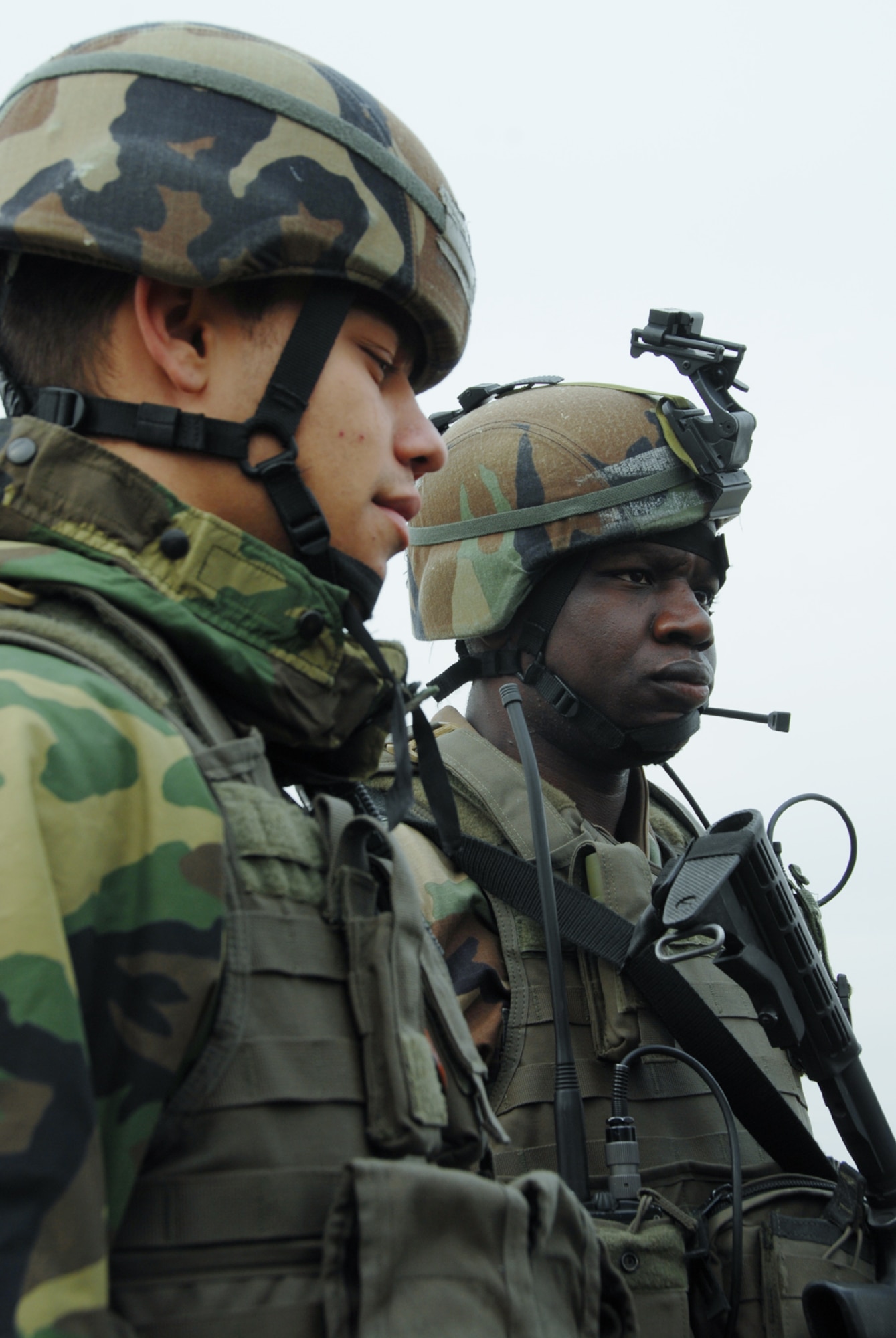OSAN AIR BASE, Republic of Korea --  Airman 1st Class Joshua Mejia, left, and 1st Lt. Schneider Rislin, 51st Security Forces Squadron, stand guard at an ECP here Monday. Beverly Bulldog 08-01 scenarios test Team Osan's ability to defend the base and conduct daily operations in a combat environment.  (U.S. Air Force Photo by Airman First Class Chad Strohmeyer