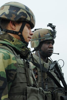 OSAN AIR BASE, Republic of Korea --  Airman 1st Class Joshua Mejia, left, and 1st Lt. Schneider Rislin, 51st Security Forces Squadron, stand guard at an ECP here Monday. Beverly Bulldog 08-01 scenarios test Team Osan's ability to defend the base and conduct daily operations in a combat environment.  (U.S. Air Force Photo by Airman First Class Chad Strohmeyer