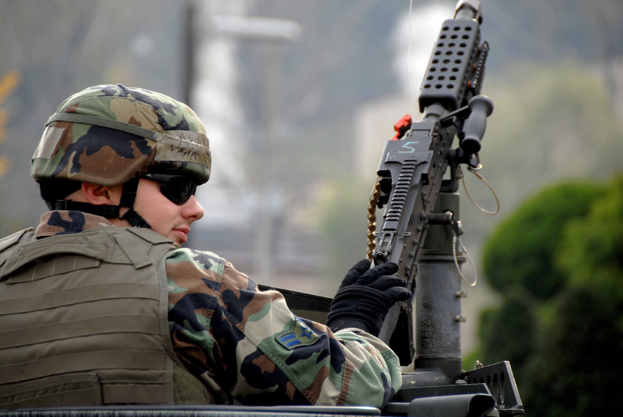 OSAN AIR BASE, Republic of Korea -- A 51st Security Forces Squadron Airman mans a gun in the turret on top of a hummer during a peninsula-wide exercise here Nov. 5.  Beverly Bulldog 08-01 scenarios test Team Osan's ability to defend the base and conduct daily operations in a combat environment.  (U.S. Air Force Photo by Airman First Class Chad Strohmeyer