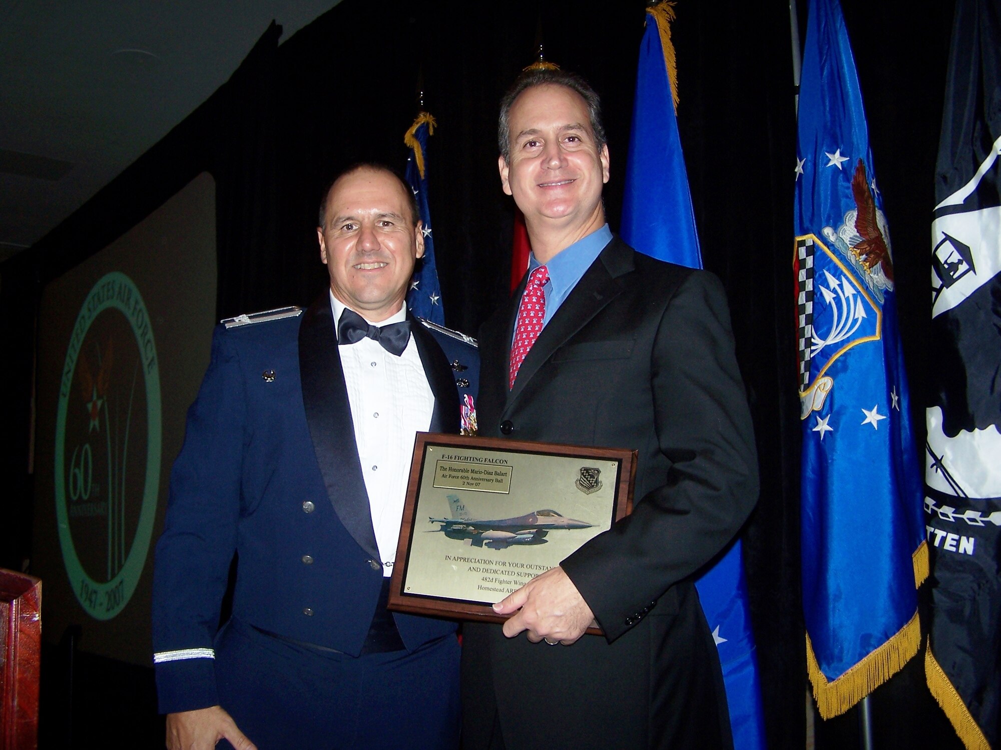 Col. Randy Falcon, 482nd Fighter Wing commander presents a wing plaque to guest speaker U.S. Rep. Mario Diaz-Balart, 25th District of Florida, Nov. 2, 2007. Congressman Diaz-Balart addressed the attendees of  Homestead Air Reserve Base’s "Heritage to Horizons" Air Force Ball.  The night’s event was part of a year long world-wide celebration commemorating the 60th Anniversary of the U.S. Air Force and local military members recently deployed. The gala was co-hosted by the 482nd Fighter Wing, Homestead ARB, Fla., and the Greater Homestead/Florida City Chamber of Commerce Military Affairs Committee. (U.S. Air Force photo/Lt. Col. Tom Davis)