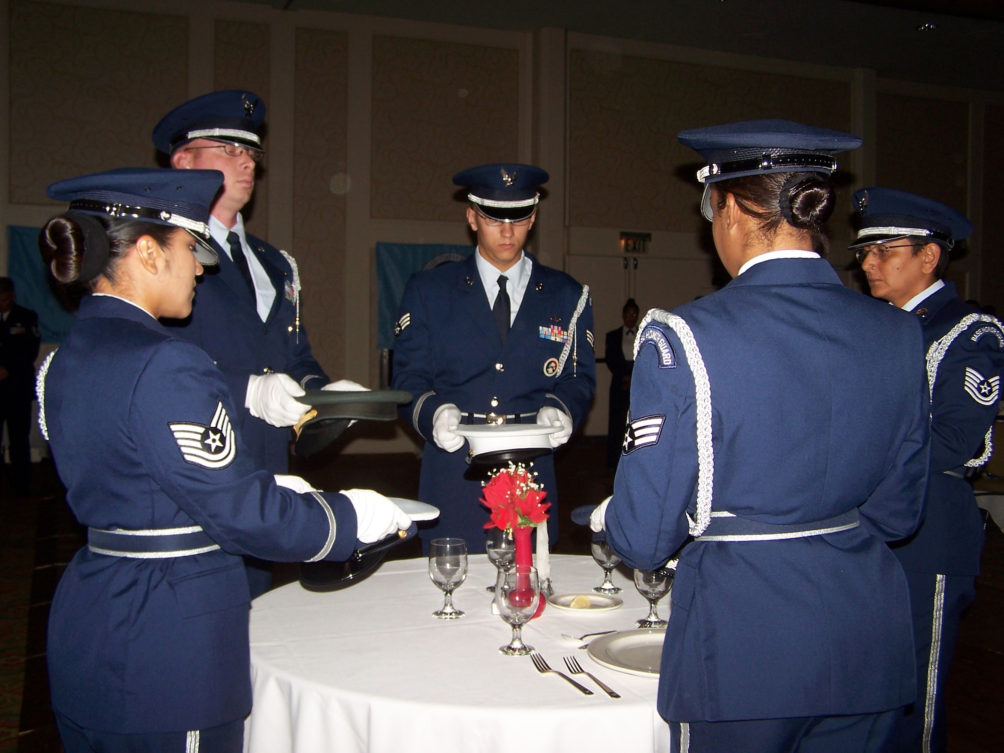 Members of the Homestead Air Reserve Base honor guard, conduct the POW/MIA ceremony at the "Heritage to Horizons" Air Force Ball Nov. 2, 2007.  The ceremony centers around a small table, which occupies a place of dignity and honor near the head table. It is set for one, symbolizing the fact that members of all our armed forces are missing from our ranks. The night’s event is part of a year long world-wide celebration commemorating the 60th Anniversary of the U.S. Air Force and local military members recently deployed. The gala was co-hosted by the 482nd Fighter Wing, Homestead ARB, Fla., and the Greater Homestead/Florida City Chamber of Commerce Military Affairs Committee. (U.S. Air Force photo/Tim Norton) 

