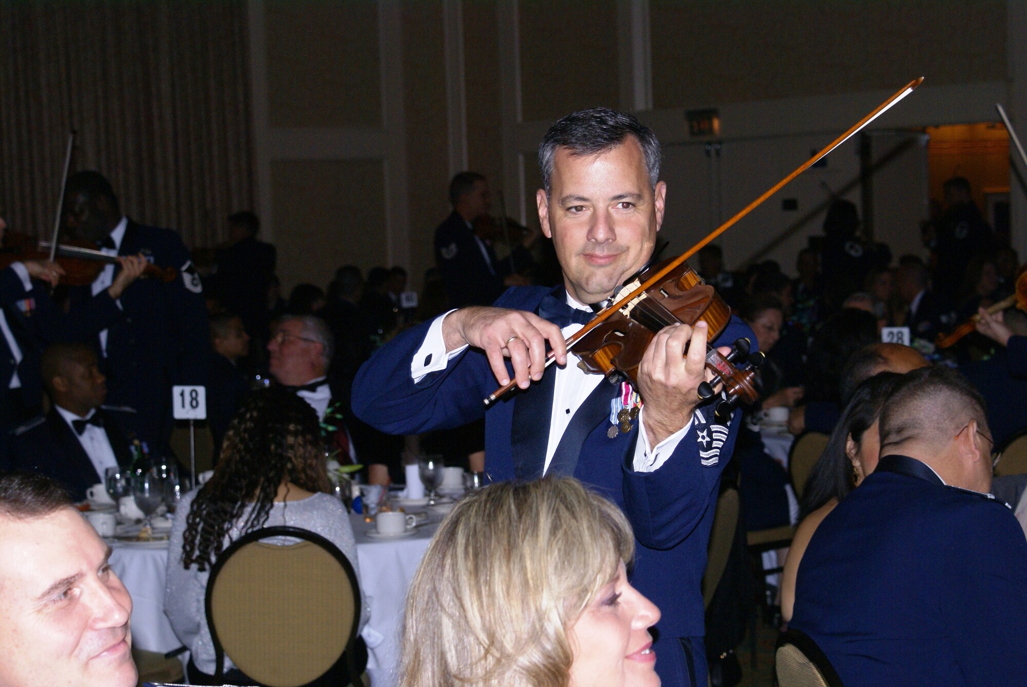SMSgt William Tortolano, of The Air Force Strings plays violin for over 500 military and civilian personnel attending Homestead Air Reserve Base’s "Heritage to Horizons" Air Force ball, Nov. 2, 2007. Since 1954, The Air Force Strolling Strings has had the honor of performing at the White House for every president from Eisenhower to Clinton. The Air Force Strings is one of the most diverse and flexible units of The United States Air Force Band. The night’s event was part of a year long celebration commemorating the 60th Anniversary of the U.S. Air Force and recently deployed military members. The gala was co-hosted by the 482nd Fighter Wing, Homestead ARB, Fla., and the Greater Homestead/Florida City Chamber of Commerce Military Affairs Committee. (U.S. Air Force photo/Tim Norton)