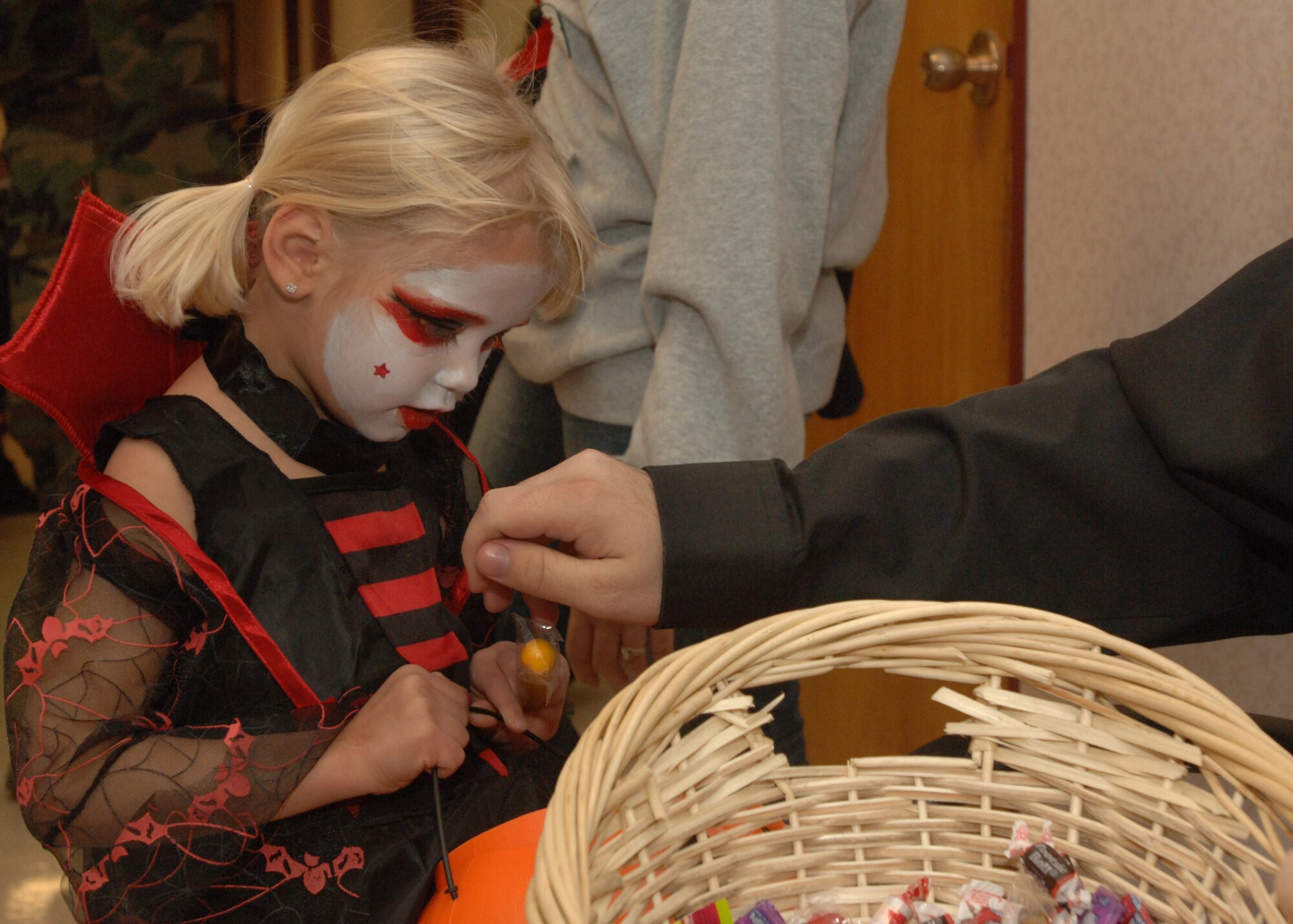 Alaska Falch, daughter of Senior Airman Crystal and Staff Sgt. John Falch,  received  candy from enthusiastic medical personnel during this year’s trick or treating in the 319th Medical Group Oct. 31. (U.S. Air Force photo/Airman 1st Class Daniel Hernholm)