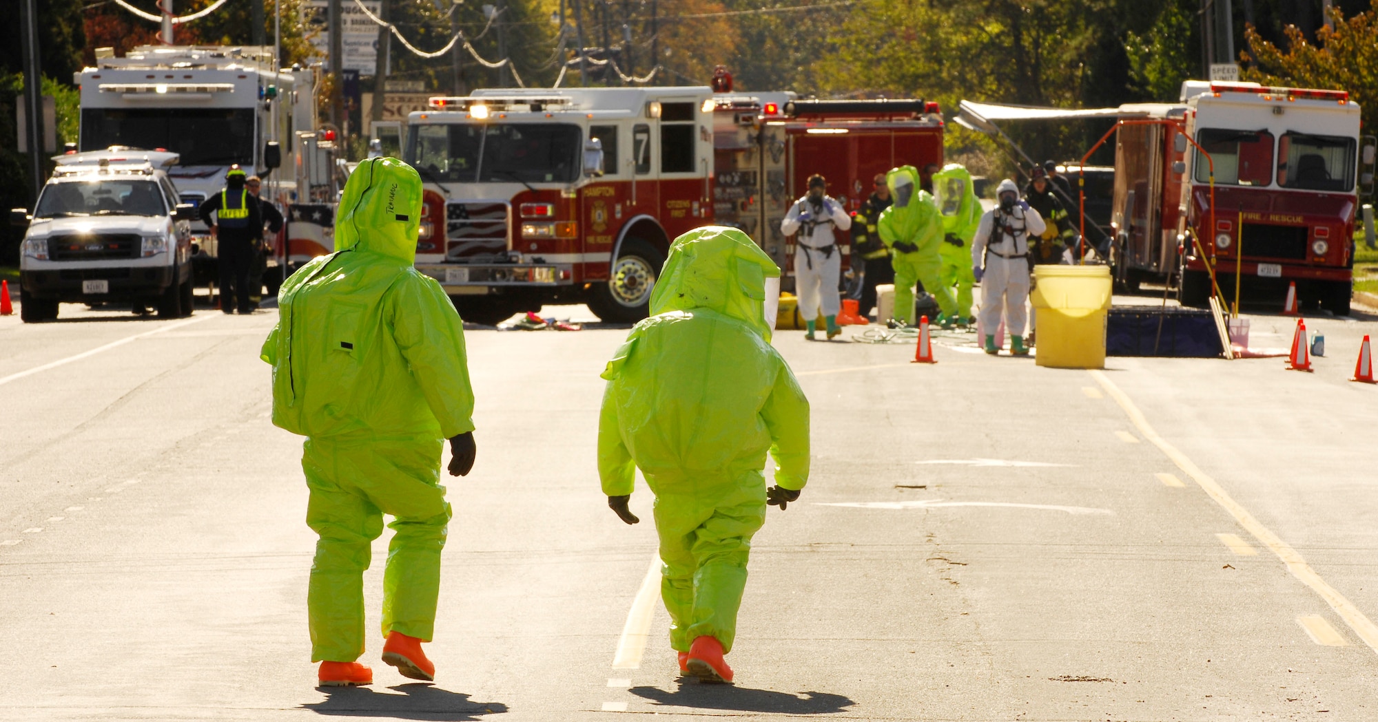 LANGLEY AFB, Va. -- Fred Schmid (left) and Syril Gillies (right), both medic fire fighters with the Hampton Fire Department Hazmat Team, walk back to the on scene  control point for decontamination after containing a simulated chlorine spill during a Major Accident Response Exercise Nov. 7. The MARE was designed to test reaction and response times as well as the recovery process of Langley and local major accident response personnel if an environmental mishap were to take place on or near the installation. (U.S. Air Force Photo/Staff Sgt Samuel Rogers)
