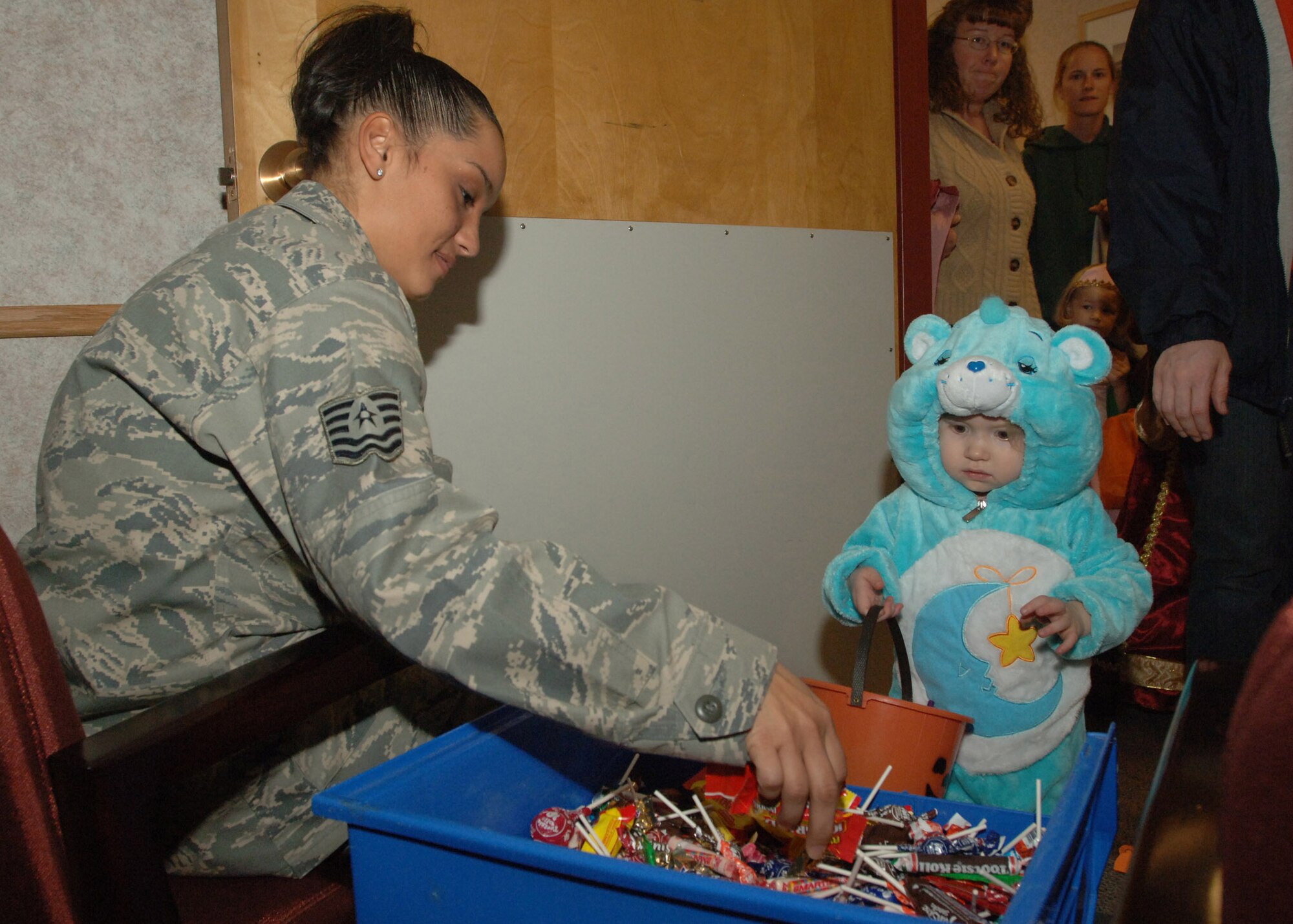 Tech Sgt. Melkys Richards, 319th Medical Group, hands out candy to costumed children during the Med Group’s annual trick-or-treat event Oct. 31. (U.S. Air Force photo/ Airman 1st Class Daniel Hernholm)

