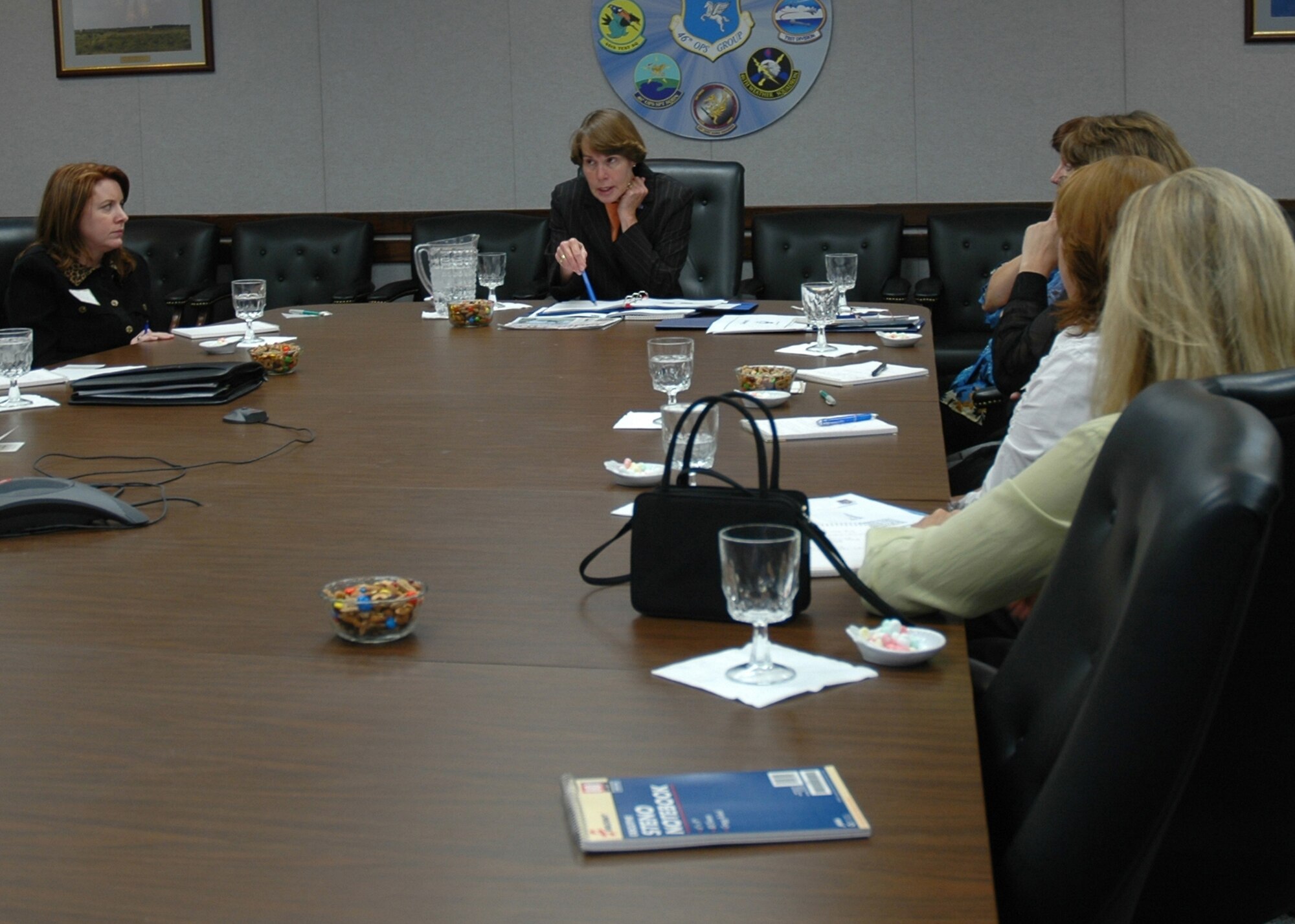 EGLIN AIR FORCE BASE, Fla. -- Vicki Carlson, center, wife of Gen. Bruce Carlson, Air Force Materiel Command commander, addresses several commanders' wives here Nov. 7. Mrs. Carlson also addressed members of Eglin's Junior Force Council during her visit. General Carlson was invited to Eglin to attend the Worldwide Contracting Conference, where he was the guest speaker. (Photo by Staff Sgt. LuCelia Ball)