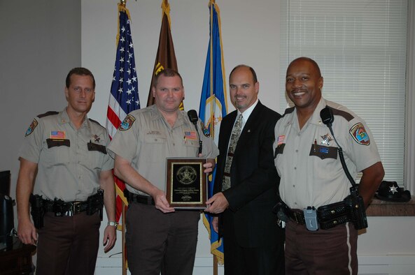 Detention Deputy Jeffrey Grates receives a citation from Hennepin County Sheriff Rich Stanek. Left to Right; Hennepin County Chief Deputy Michael Carlson, Detention Deputy Jeffrey Grates, Sheriff Rich Stanek, Inspector Chester Cooper III.Courtesy Photo