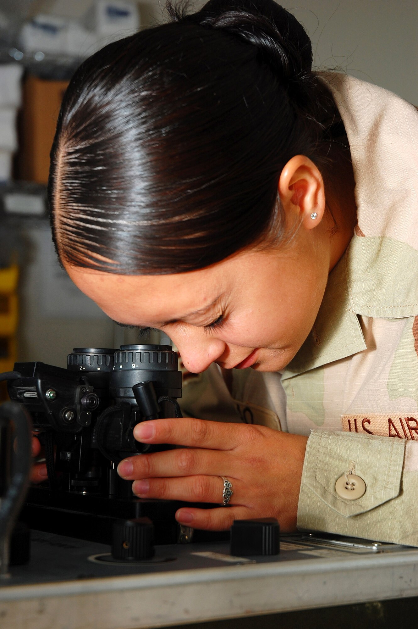 Senior Airman Christina Arao performs a periodic inspection of a set of night-vision goggles Nov. 2 in Southwest Asia. Airman Arao, a 386th Expeditionary Operations Group aircrew life support technician, is deployed from Pope Air Force Base, N.C. (U.S. Air Force photo/Staff Sgt. Tia Schroeder)

