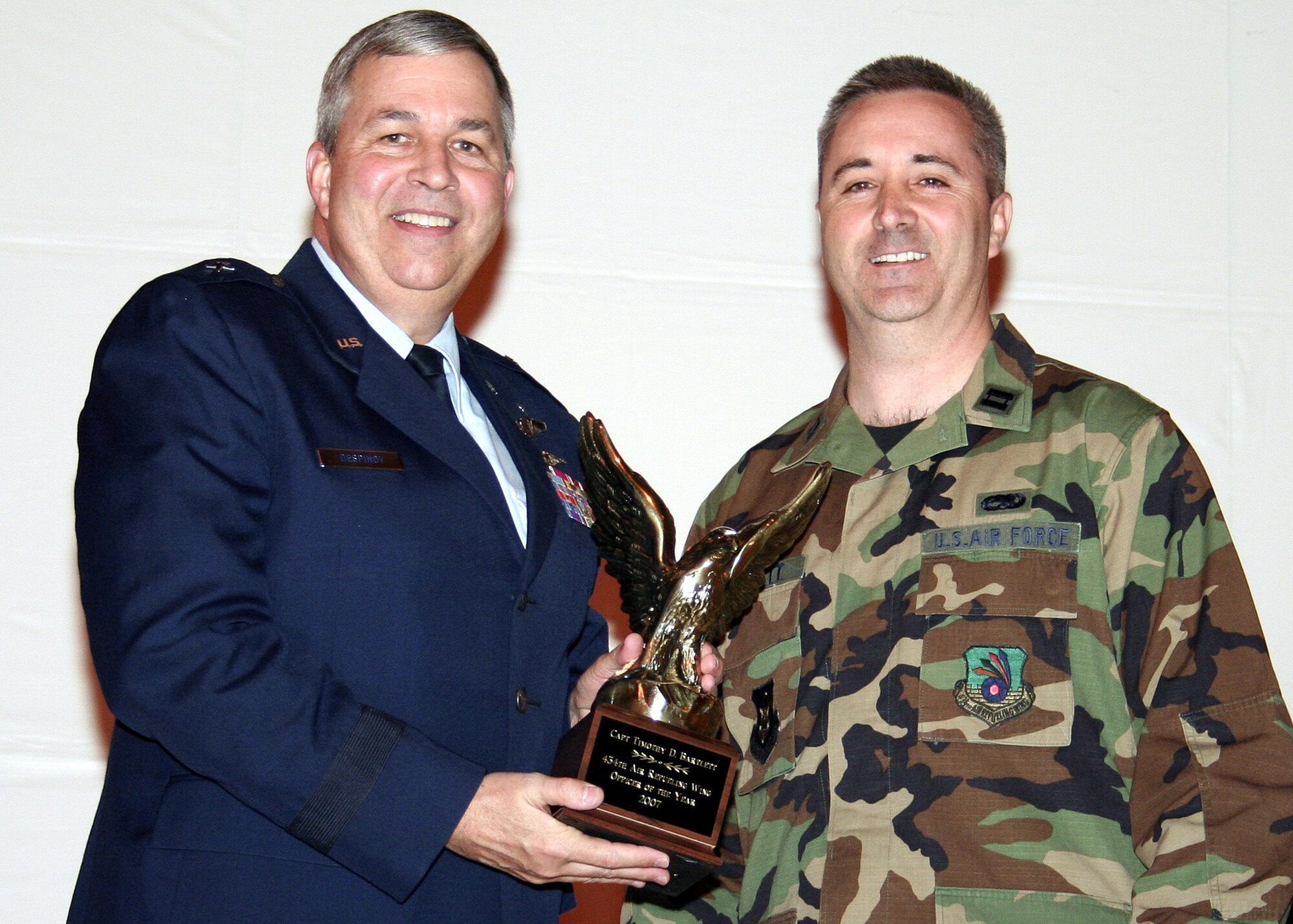 GRISSOM AIR RESERVE BASE, Ind., -- Brig. Gen. Dean Despinoy, left, 434th Air Refueling Wing commander, presents Capt. Timothy Bartlett, 434th Aircraft Maintenance Squadron, a trophy for his selection as Grissom's Officer of the Year. (U.S. Air Force photo/Tech. Sgt. Patrick Kuminecz)
