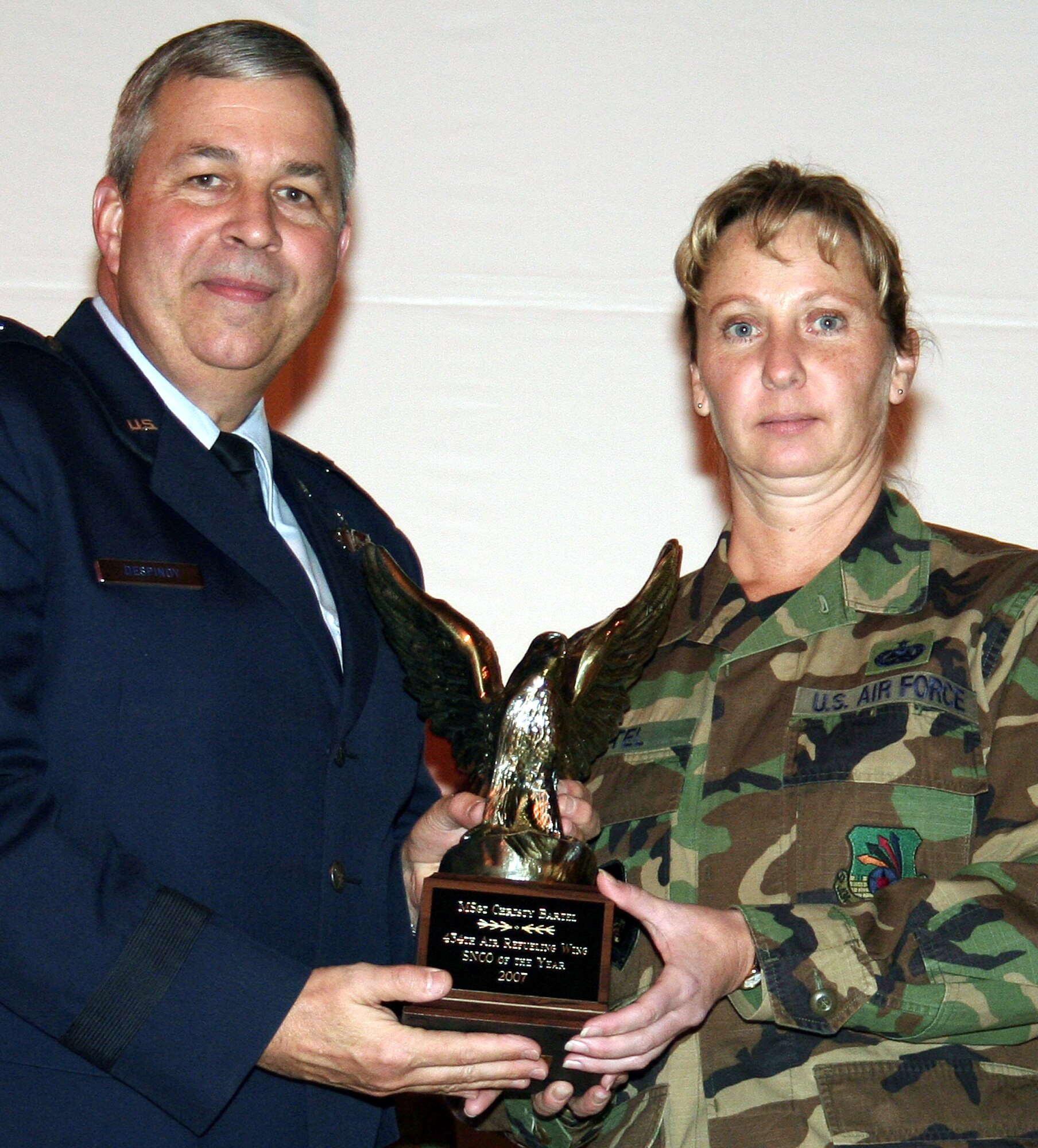 GRISSOM AIR RESERVE BASE, Ind., -- Brig. Gen. Dean Despinoy, 434th Air Refueling Wing commander, presents a trophy to Master Sgt. Christy Bartel, 434th Maintenance Operations Flight, for her selection as the wing's senior NCO of the Year. (U.S. Air Force photo/Tech. Sgt. Patrick Kuminecz)
