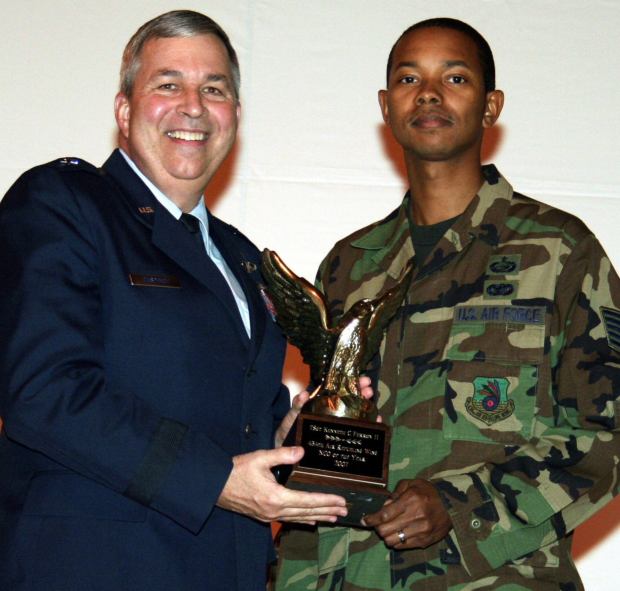 GRISSOM AIR RESERVE BASE, Ind., -- Brig. Gen. Dean Despinoy, 434th Air Refueling Wing commander, left, presents a trophy to Tech. Sgt. Kenneth Ferron, 434th Military Personnel Flight, for his selection as Grissom's NCO of the Year. (U.S. Air Force photo/Tech. Sgt. Patrick Kuminecz)