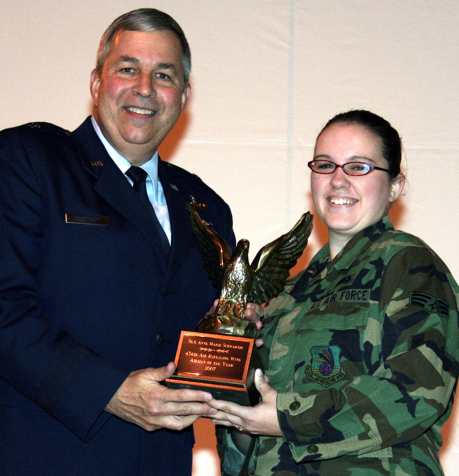 GRISSOM AIR RESERVE BASE, Ind., -- Brig. Gen Dean Despinoy, 434th Air Refueling Wing commander, presents a trophy to Senior Airman Anne Marie Schwartze, 434th Logistics Readiness Squadron, for her selection as Grissom's Airman of the Year. (U.S. Air Force photo/Tech. Sgt. Patrick Kuminecz)