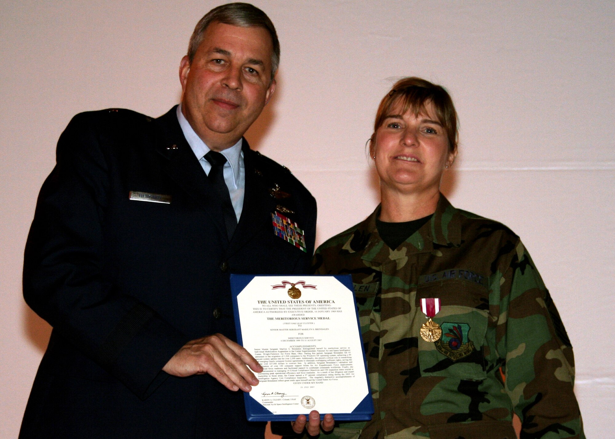 GRISSOM AIR RESERVE BASE, Ind., -- Brig. Gen. Dean Despinoy, 434th Air Refueling Wing commander, presents an Air Force Meritorious Service Medal to Senior Master Sgt. Marilyn Brendalen, 434th ARW, during the wing commander's call held in November.  Sergeant Brendalen is the assistant to the 434th ARW command chief. (U.S. Air Force photo/Tech. Sgt. Patrick Kuminecz)
