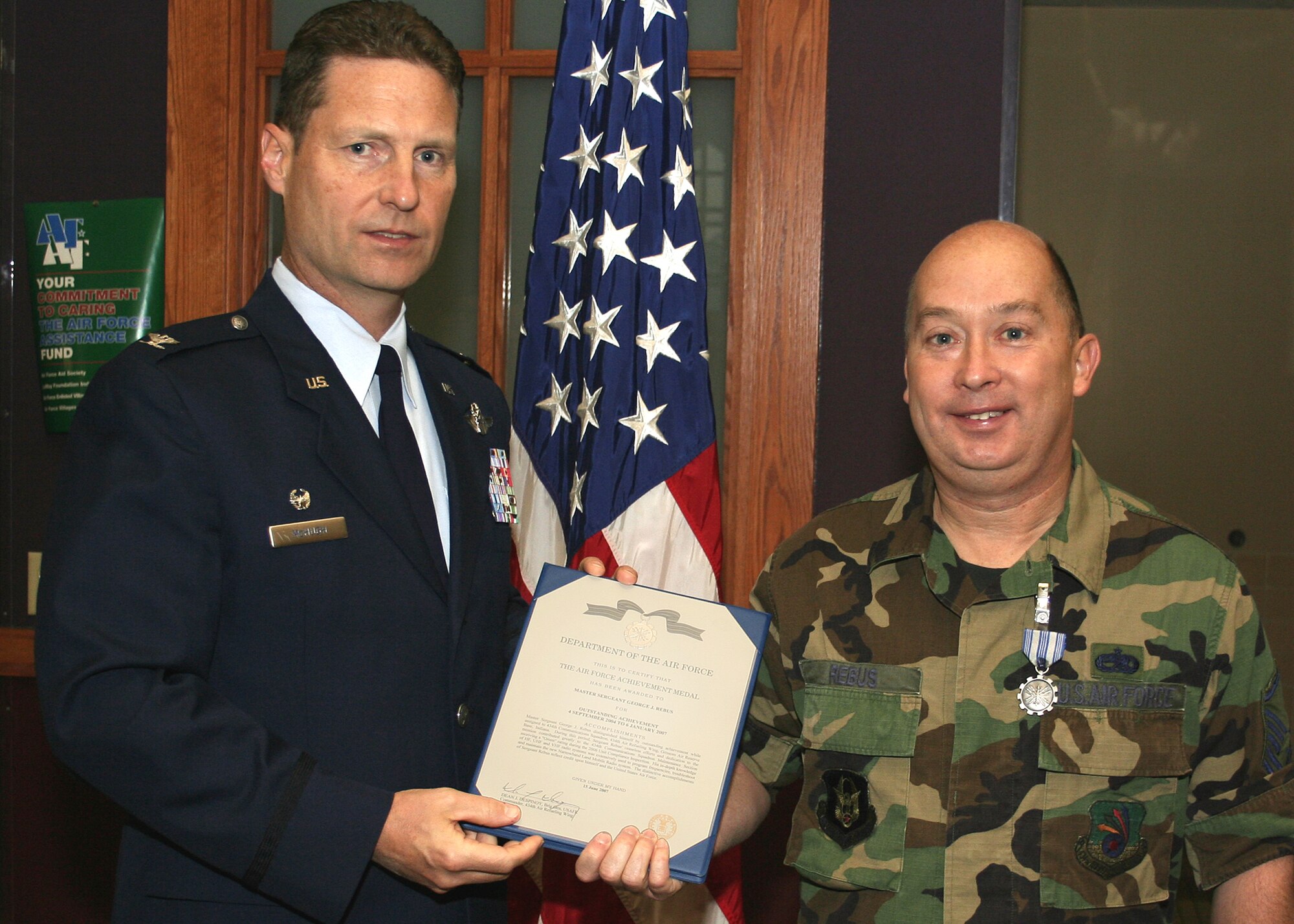 GRISSOM AIR RESERVE BASE, Ind., -- Col. Doug McHugh, left, 434th Mission Support Group commander, presents Master Sgt. George Rebus, 434th Communications Squadron, an Air Force Achievement Medal at a commander's call held during the November unit training assembly. (U.S. Air Force photo/Tech. Sgt. Patrick Kuminecz)