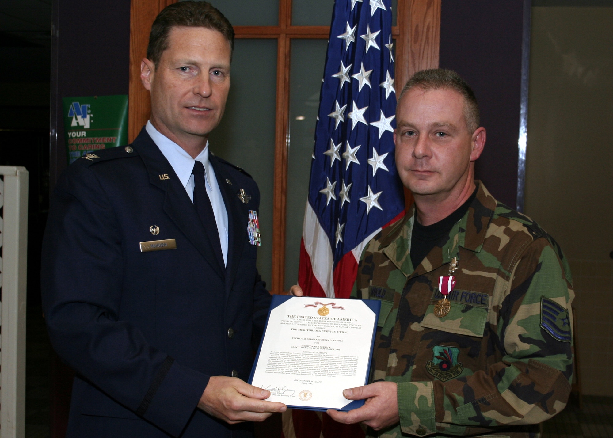 GRISSOM AIR RESERVE BASE, Ind., -- Col. Doug McHugh, 434th Mission Support Group commander, left,  presents Tech. Sgt. Brian Arnold, 434th Communications Squadron, an Air Force Meritorious Service Medal at a commander's call held during the November unit training assembly. (U.S. Air Force photo/ Tech. Sgt. Patrick Kuminecz)