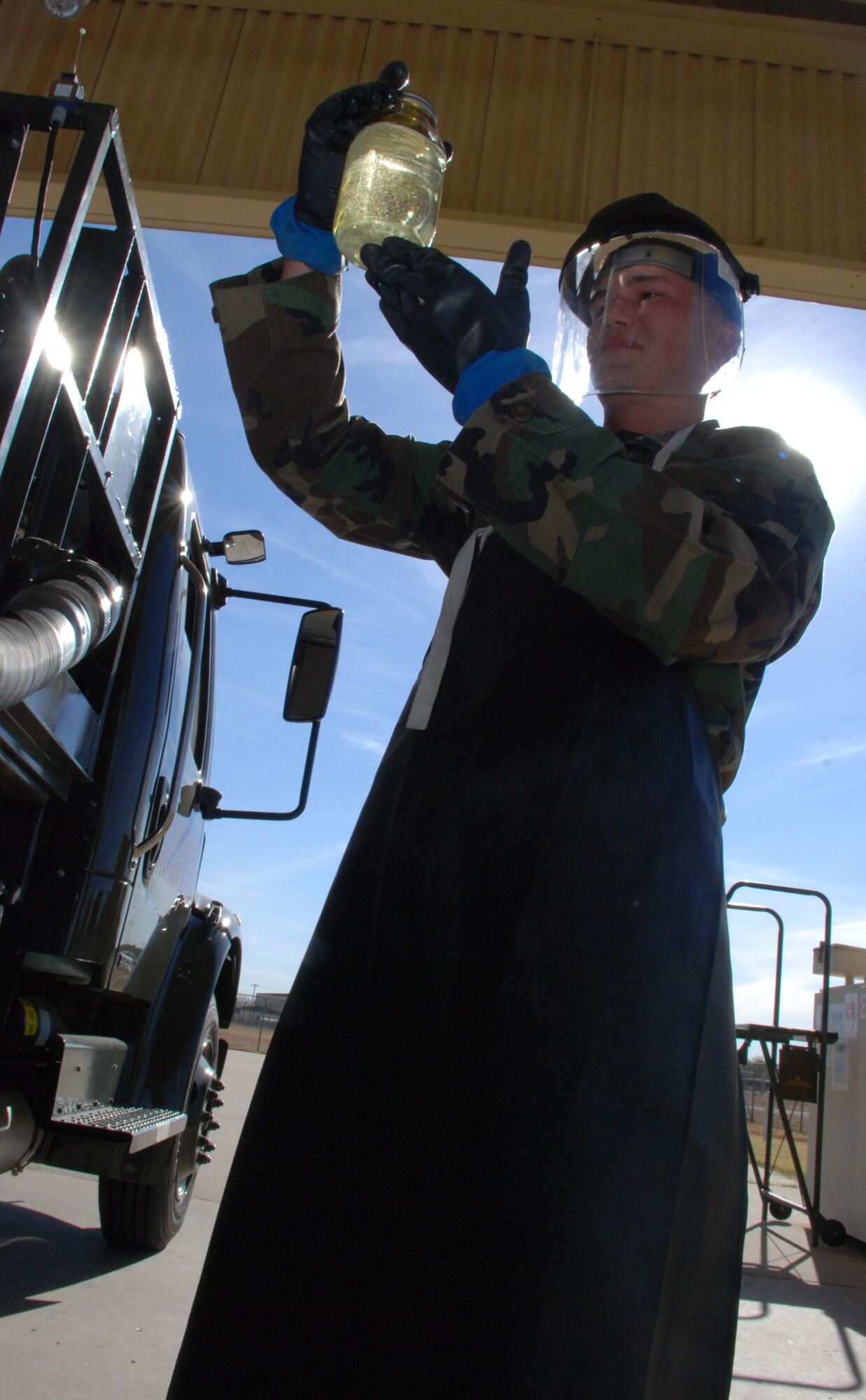 Airman Basic Chad Clark, an Airman in Training in the fuels training course, examines a fuel sample Nov. 6. Airman 1st Class Hazen Sanders, recently a student in the same course and currently assigned to the 435th Logistics Readiness Squadron, Ramstein Air Force Base, Germany, recently pumped 3 million gallons of fuel in one month, setting a new Air Force record and inspiring Airmen back at Sheppard. (U.S. Air Force photo/Airman 1st Class Jacob Corbin)