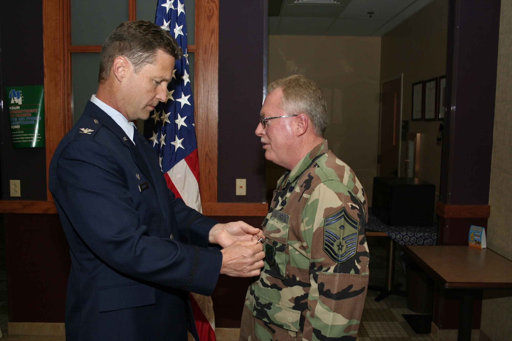 GRISSOM AIR RESERVE BASE, Ind., -- Col. Doug McHugh, 434th Mission Support Group commander, left, pins on a meritorious service medal on the chest of Senior Master Sgt. William Hamilton, 434th Security Forces Squadron first sergeant, during a group commander's call held during the November unit training assembly. (U.S. Air Force photo/Tech. Sgt. Patrick Kuminecz)