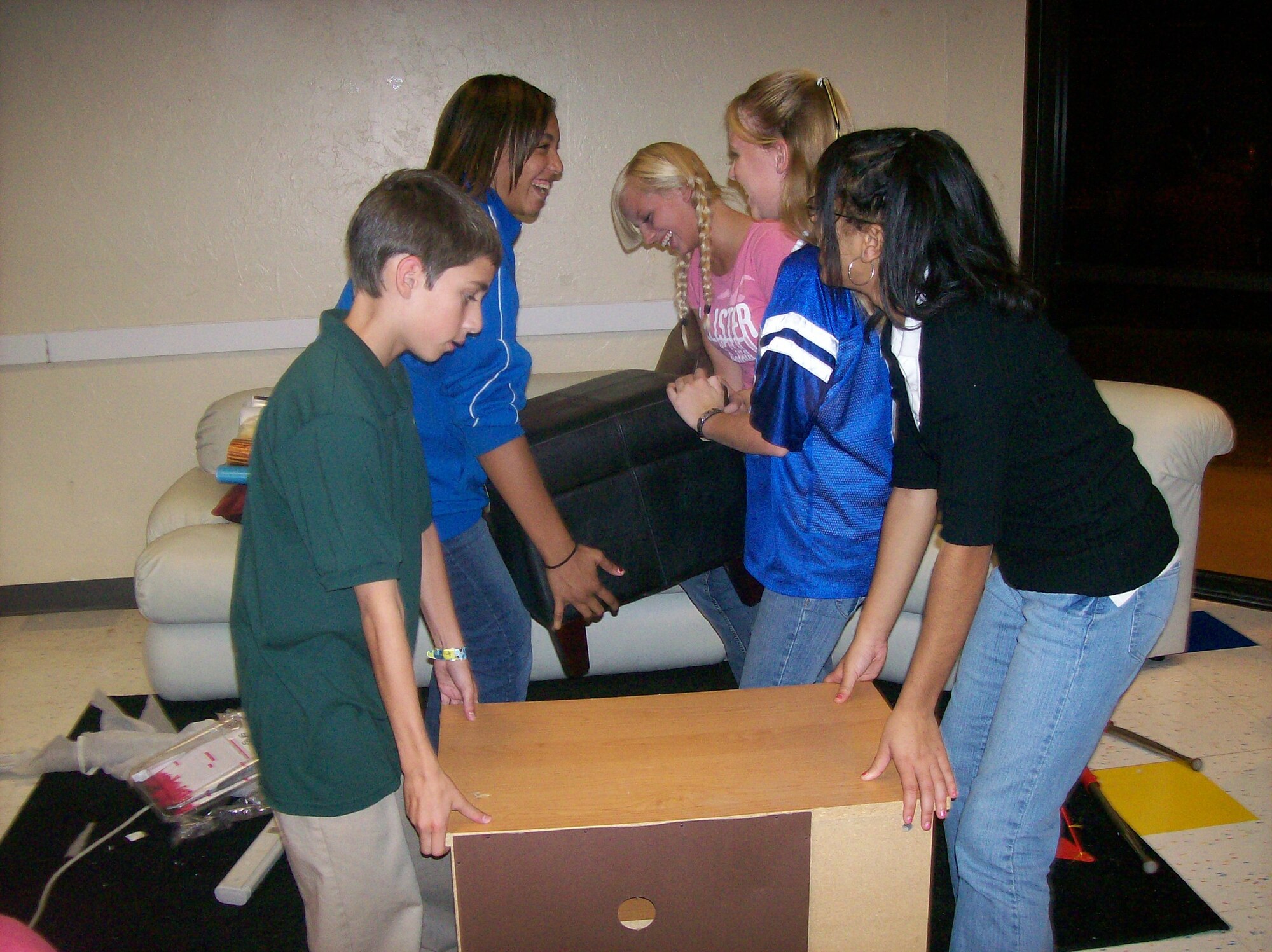 Teens arrange furniture to their liking in the teen room at the Tyndall Air Force Base youth center Monday.  (Courtesy photo)