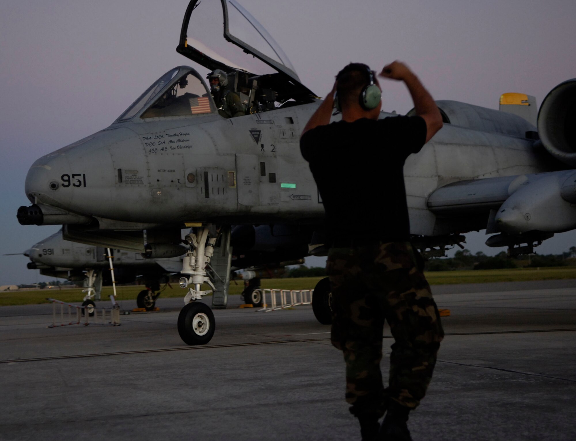 Senior Airman Alexander W. Ahlstrom, a crew chief from Spandahlem Air Base, Germany directs an A-10 towards the aircraft taxi lane before departure from MacDill AFB Fla. The A-10 unit is deployed to MacDill AFB to support exercise Atlantic Strike VI in Avon Park Fla. An F/A-18 Hornet taxies towards the runway at MacDill AFB Fla. in support of exercise Atlantic Strike VI, a U.S. Central Command Air Forces-sponsored exercise focusing on urban close air support operations. A-10 Thunderbolt II close air support aircraft are prepared for the next sortie as the Navy component departs for the Avon Park military ranges. (U.S. Air Force Photo By Airman 1st Class Stephenie Wade)